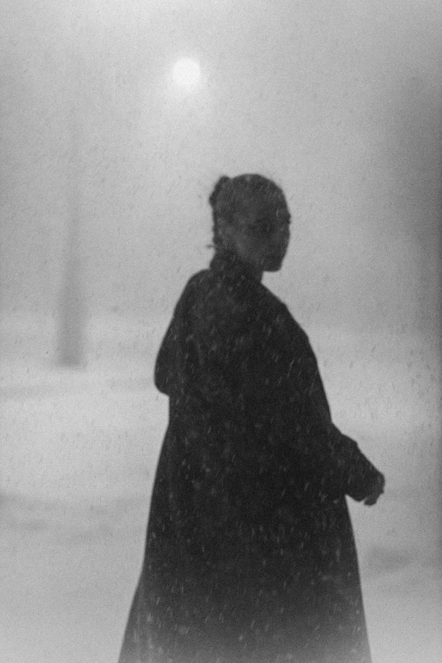 Portrait of a woman in the middle of a snow storm.