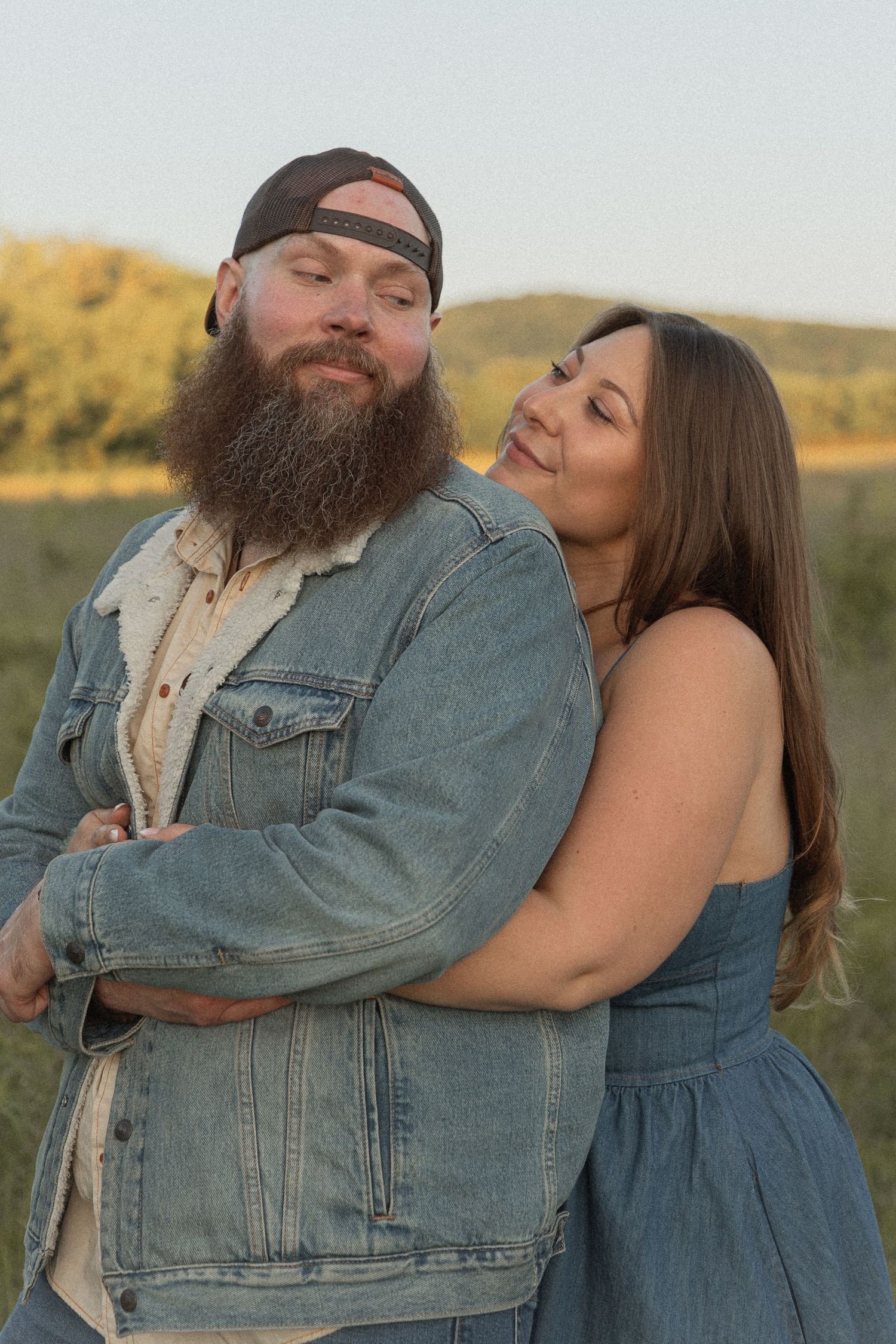 Ohio wedding photographer - Adeva Rae Photography - Couple in field with hills - western attire.