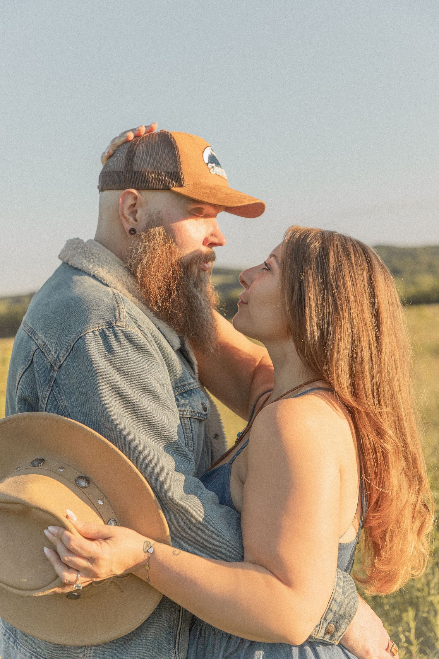 Ohio wedding photographer - Adeva Rae Photography - Couple in field with hills - western attire.