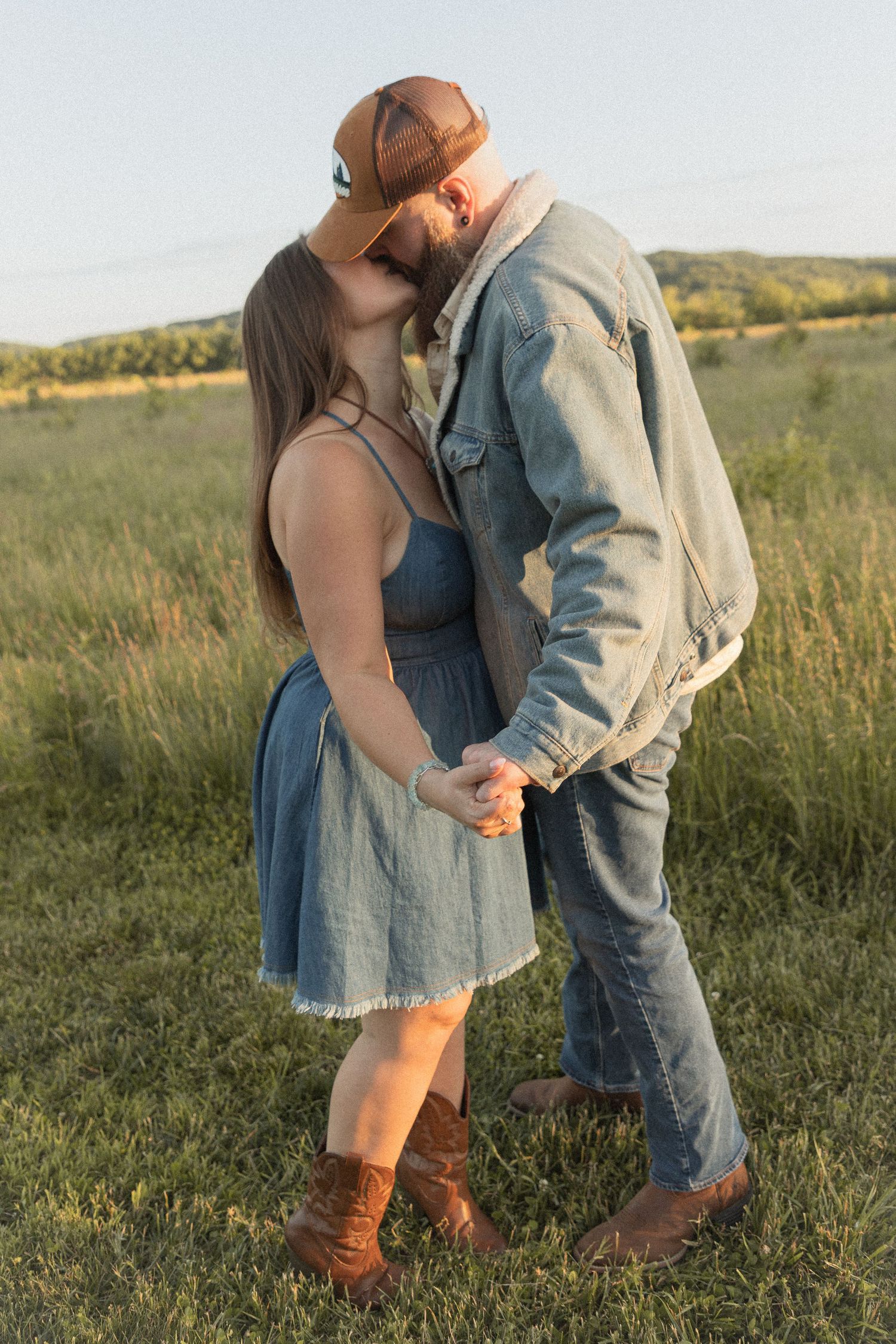 Ohio wedding photographer - Adeva Rae Photography - Couple in field with hills - western attire.