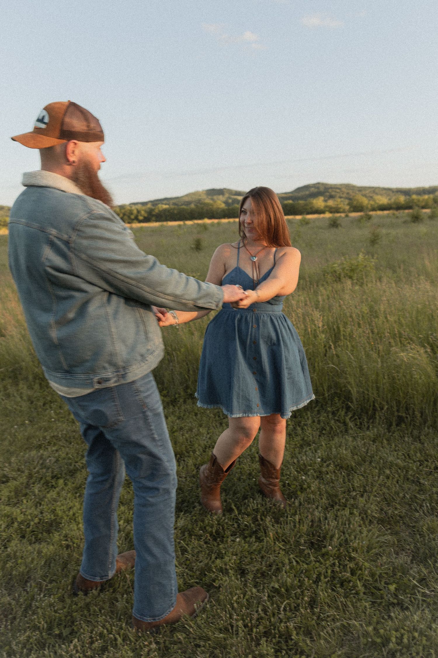 Ohio wedding photographer - Adeva Rae Photography - Couple in field with hills - western attire.