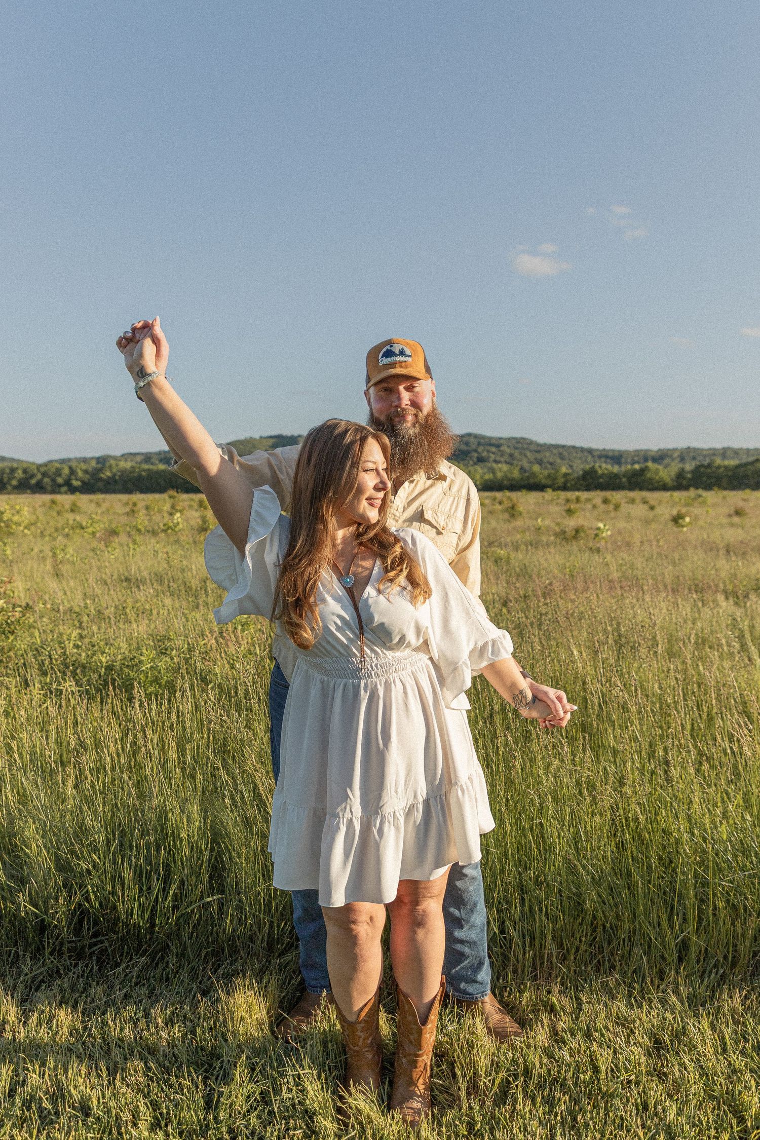 Ohio wedding photographer - Adeva Rae Photography - Couple in field with hills - western attire.