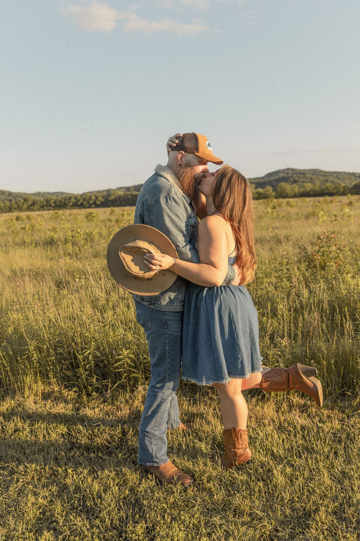 Ohio wedding photographer - Adeva Rae Photography - Couple in field with hills - western attire.