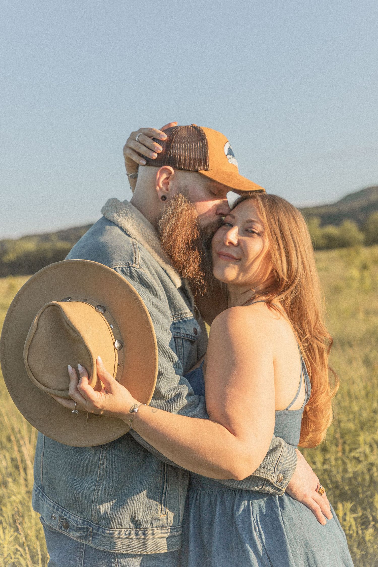 Ohio wedding photographer - Adeva Rae Photography - Couple in field with hills - western attire.