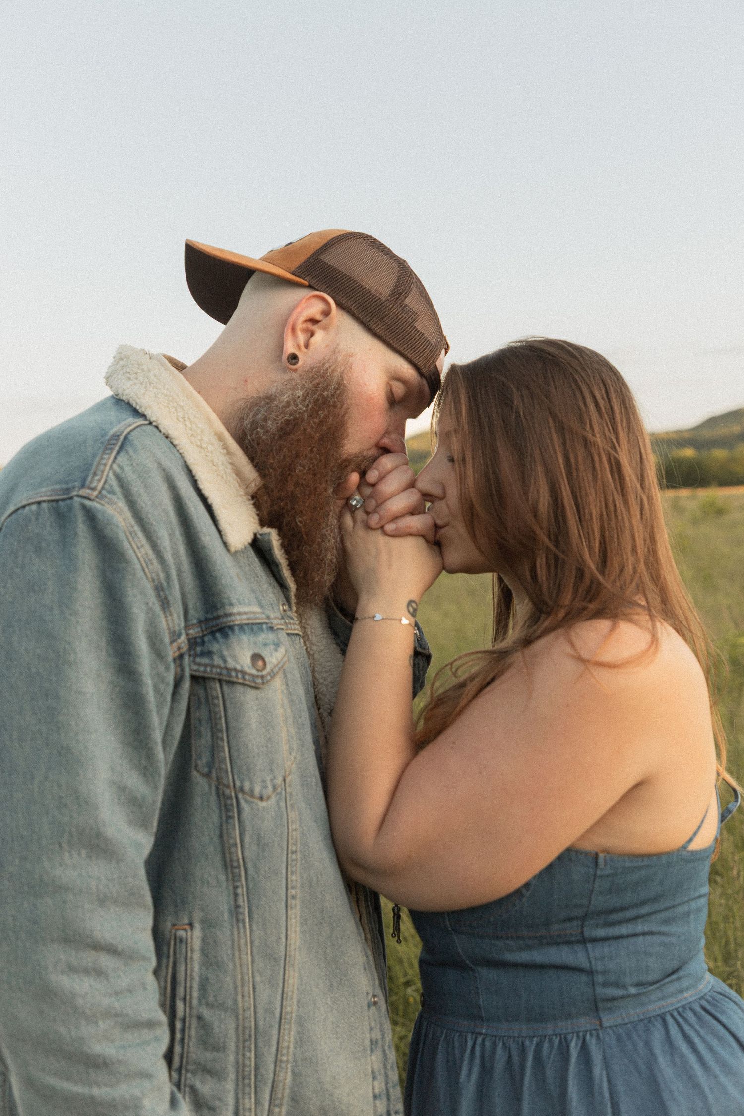 Ohio wedding photographer - Adeva Rae Photography - Couple in field with hills - western attire.