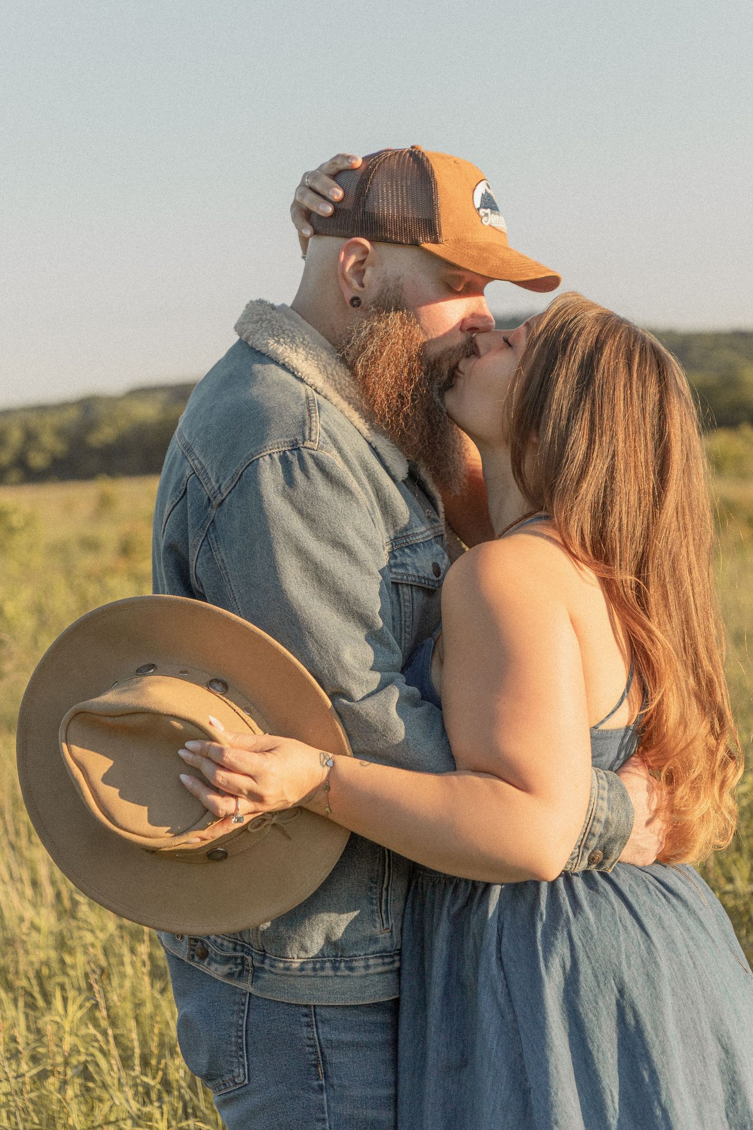 Ohio wedding photographer - Adeva Rae Photography - Couple in field with hills - western attire.