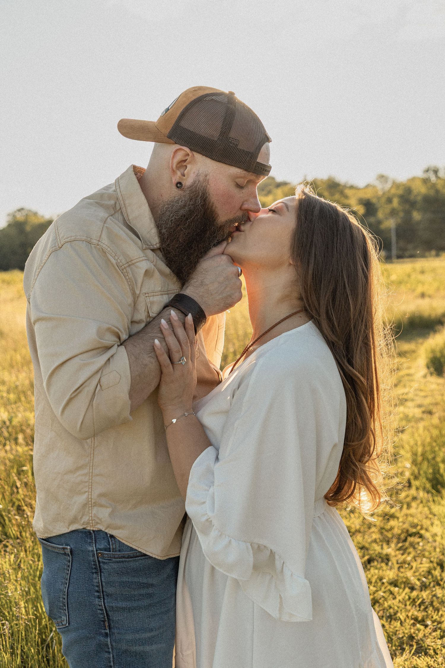 Ohio wedding photographer - Adeva Rae Photography - Couple in field with hills - western attire.