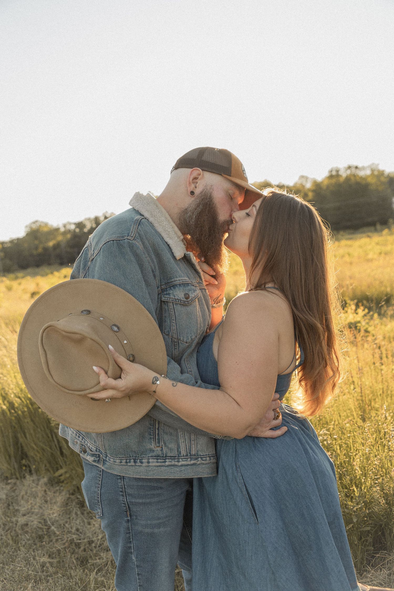 Ohio wedding photographer - Adeva Rae Photography - Couple in field with hills - western attire.