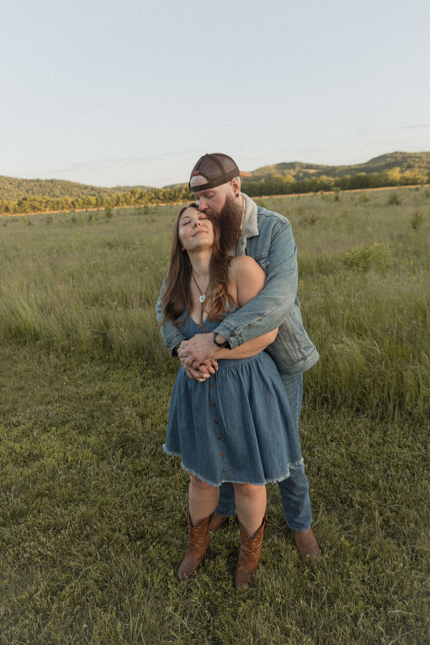 Ohio wedding photographer - Adeva Rae Photography - Couple in field with hills - western attire.
