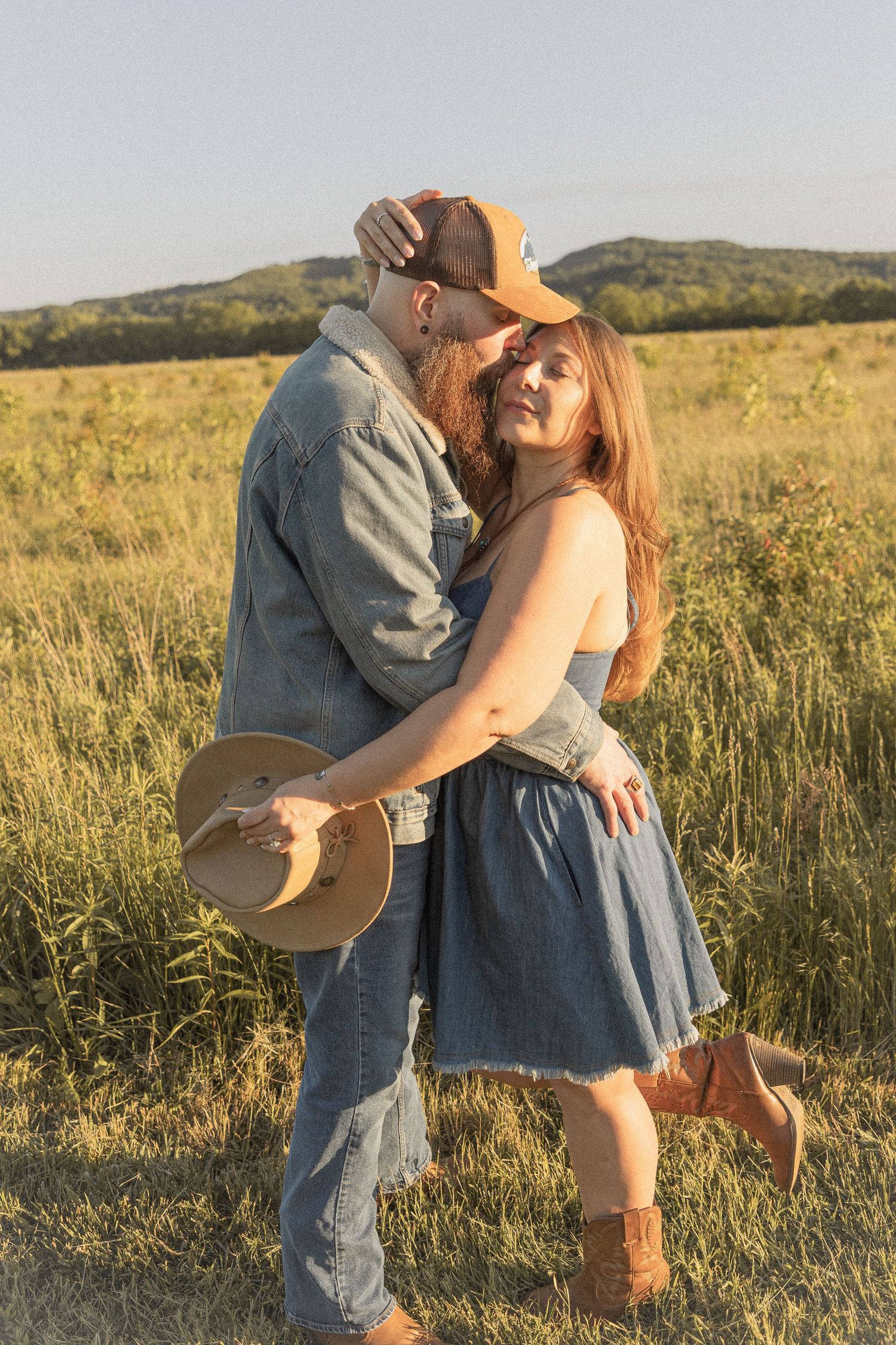Ohio wedding photographer - Adeva Rae Photography - Couple in field with hills - western attire.