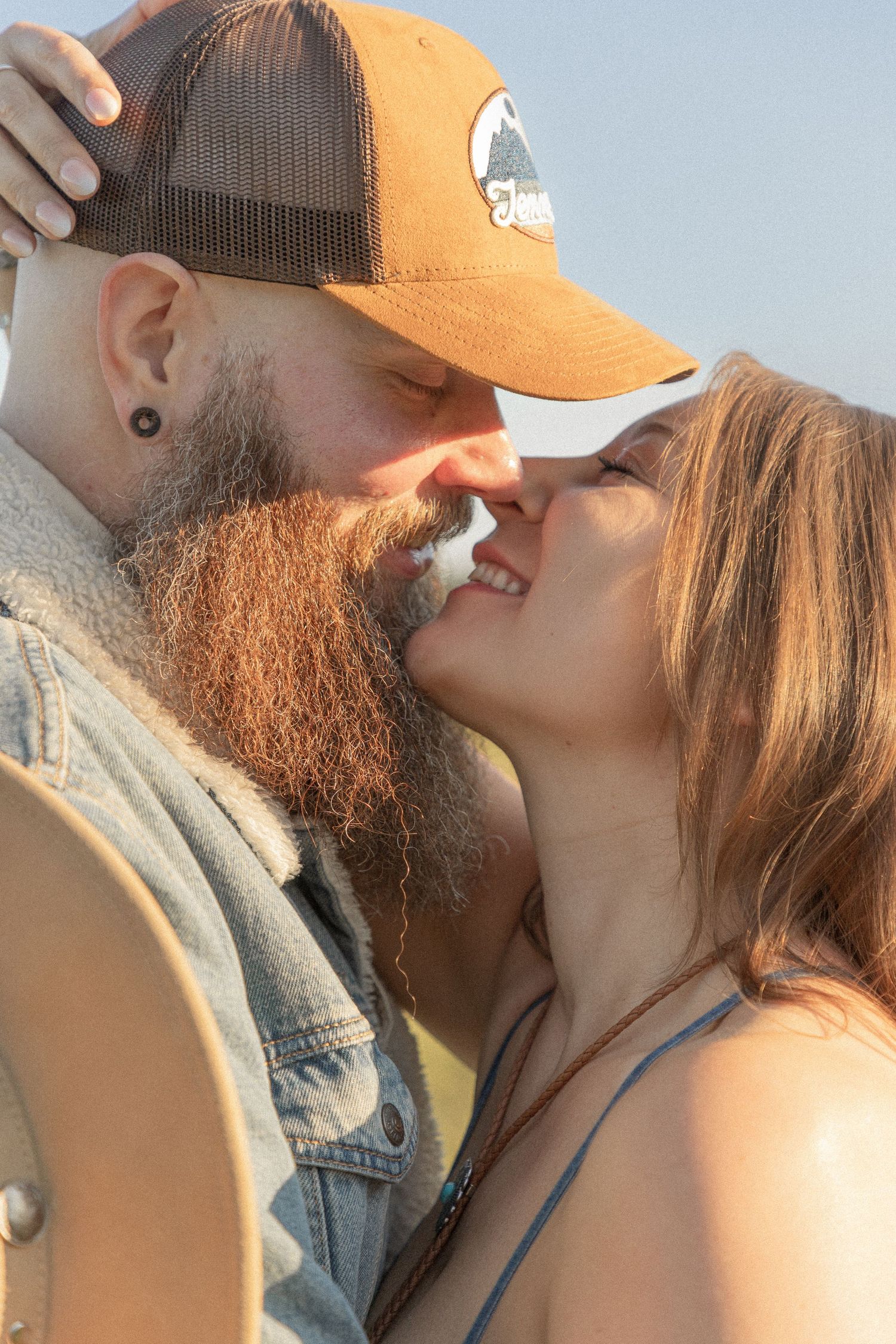 Ohio wedding photographer - Adeva Rae Photography - Couple in field with hills - western attire.