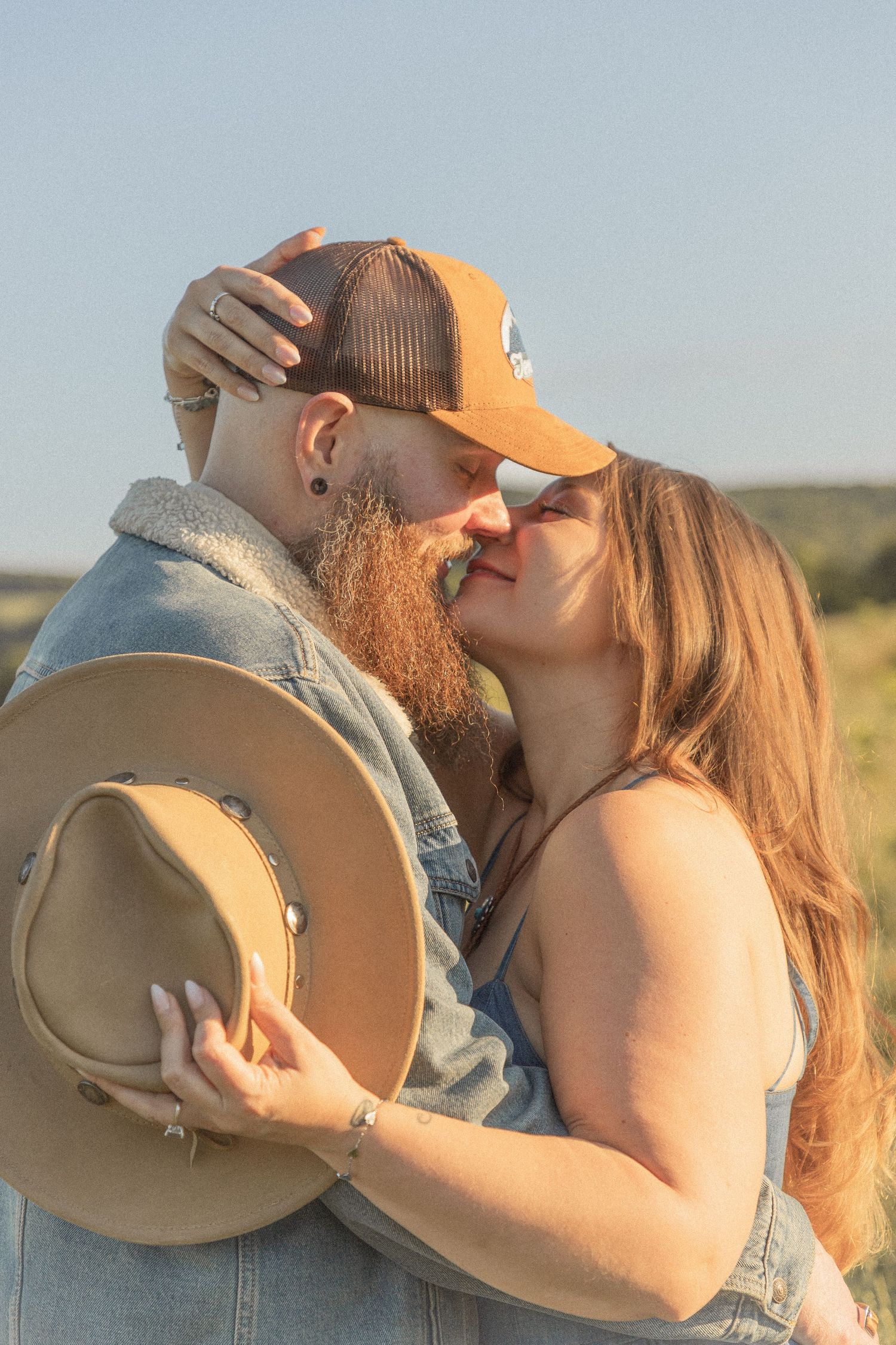 Ohio wedding photographer - Adeva Rae Photography - Couple in field with hills - western attire.