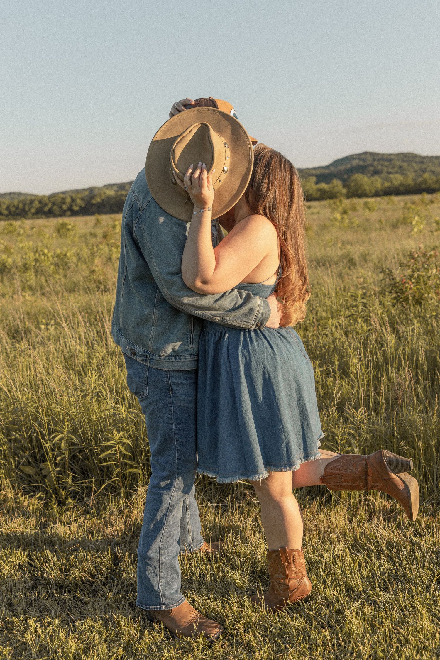 Ohio wedding photographer - Adeva Rae Photography - Couple in field with hills - western attire.