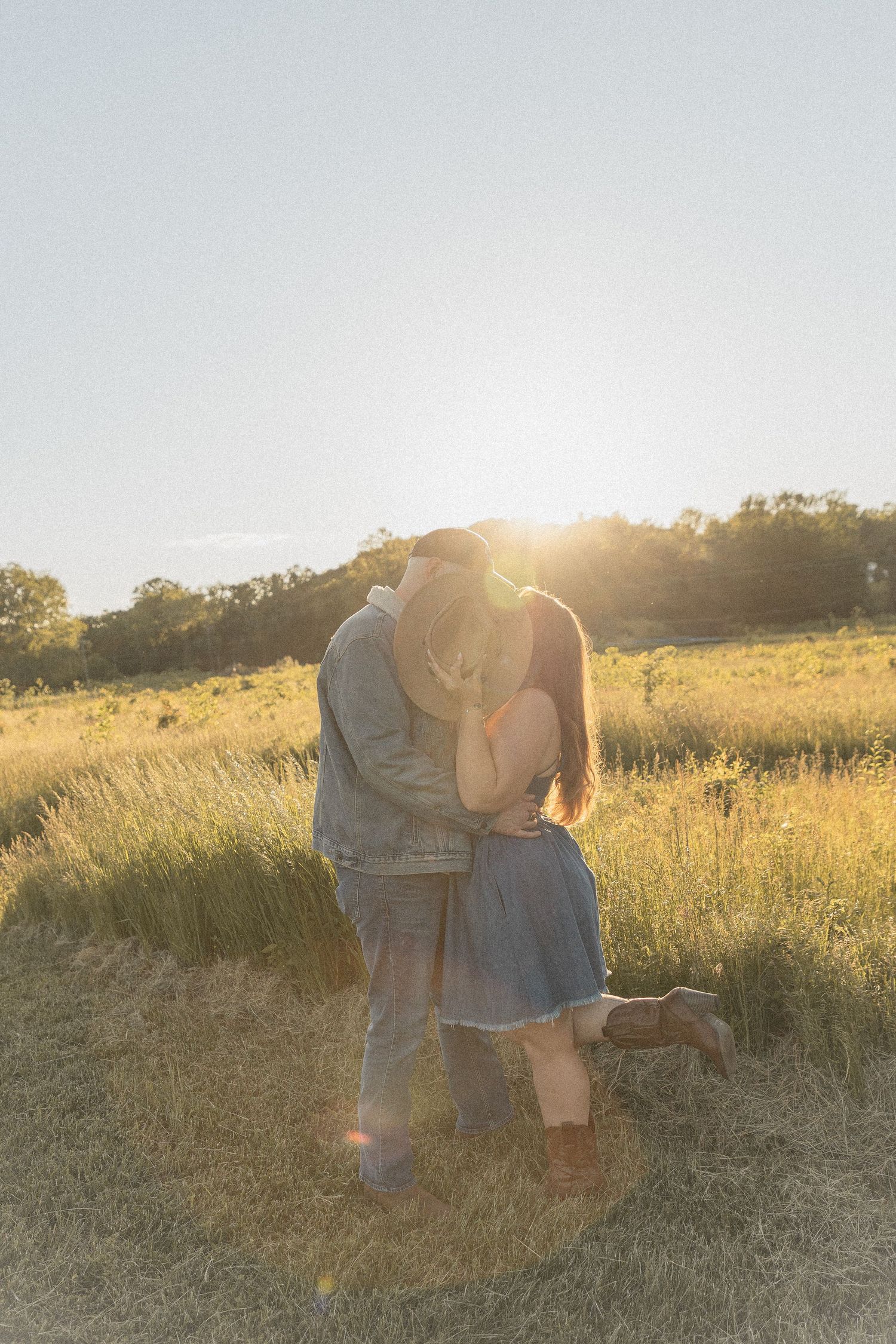 Ohio wedding photographer - Adeva Rae Photography - Couple in field with hills - western attire.