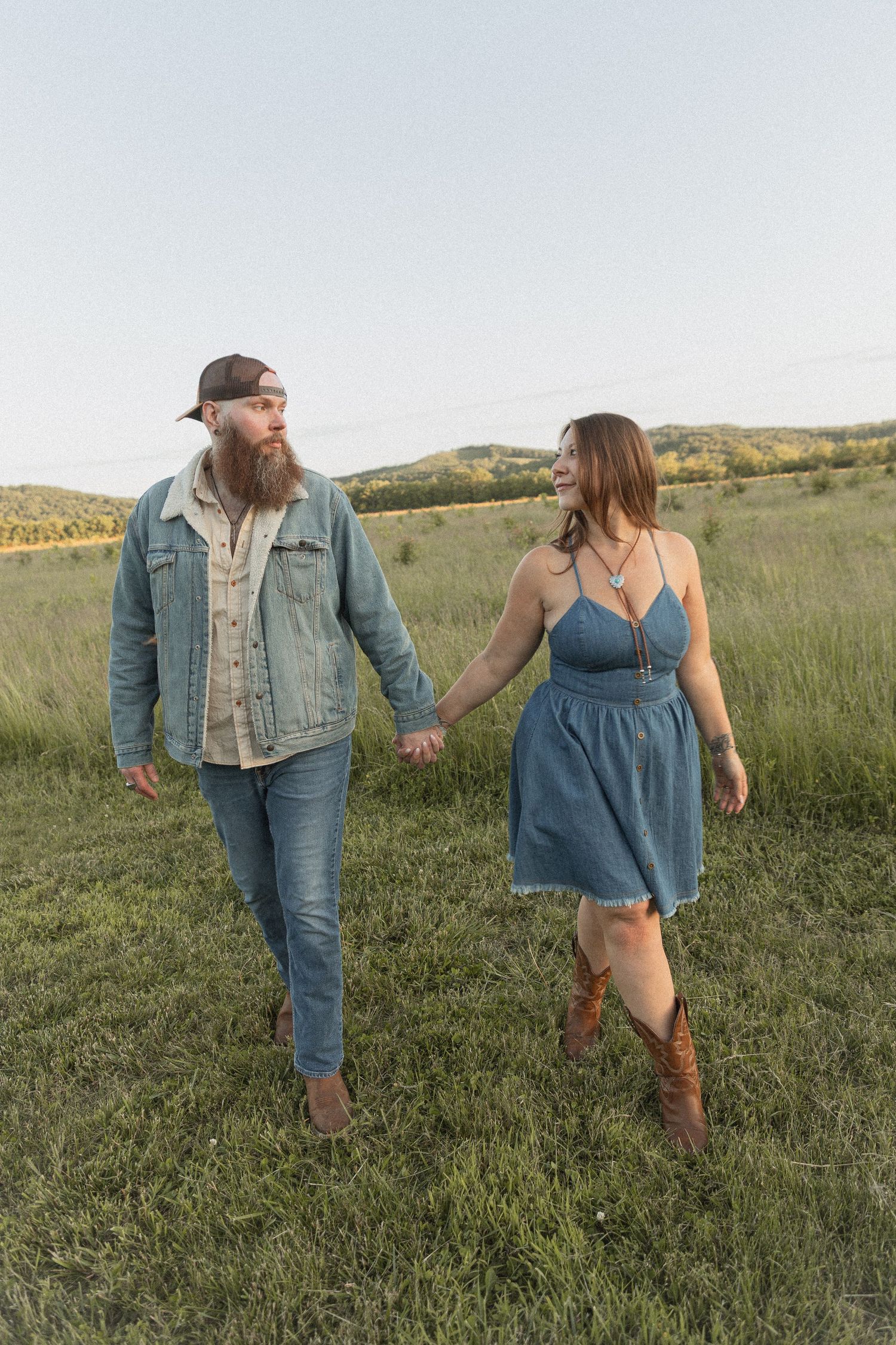Ohio wedding photographer - Adeva Rae Photography - Couple in field with hills - western attire.