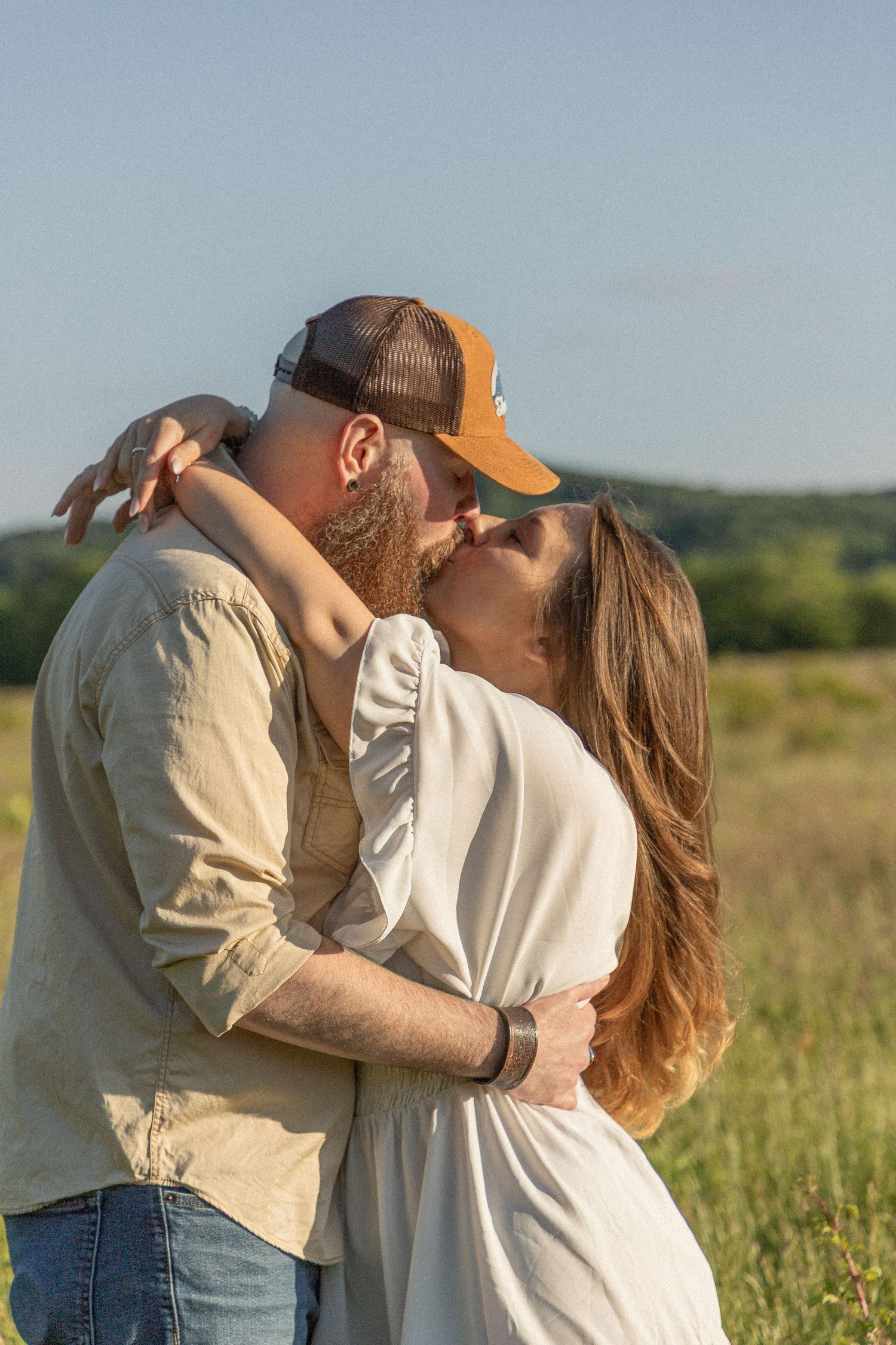 Ohio wedding photographer - Adeva Rae Photography - Couple in field with hills - western attire.