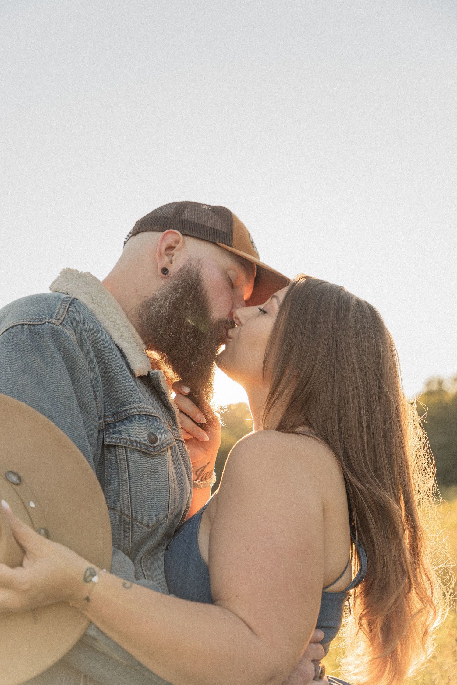 Ohio wedding photographer - Adeva Rae Photography - Couple in field with hills - western attire.