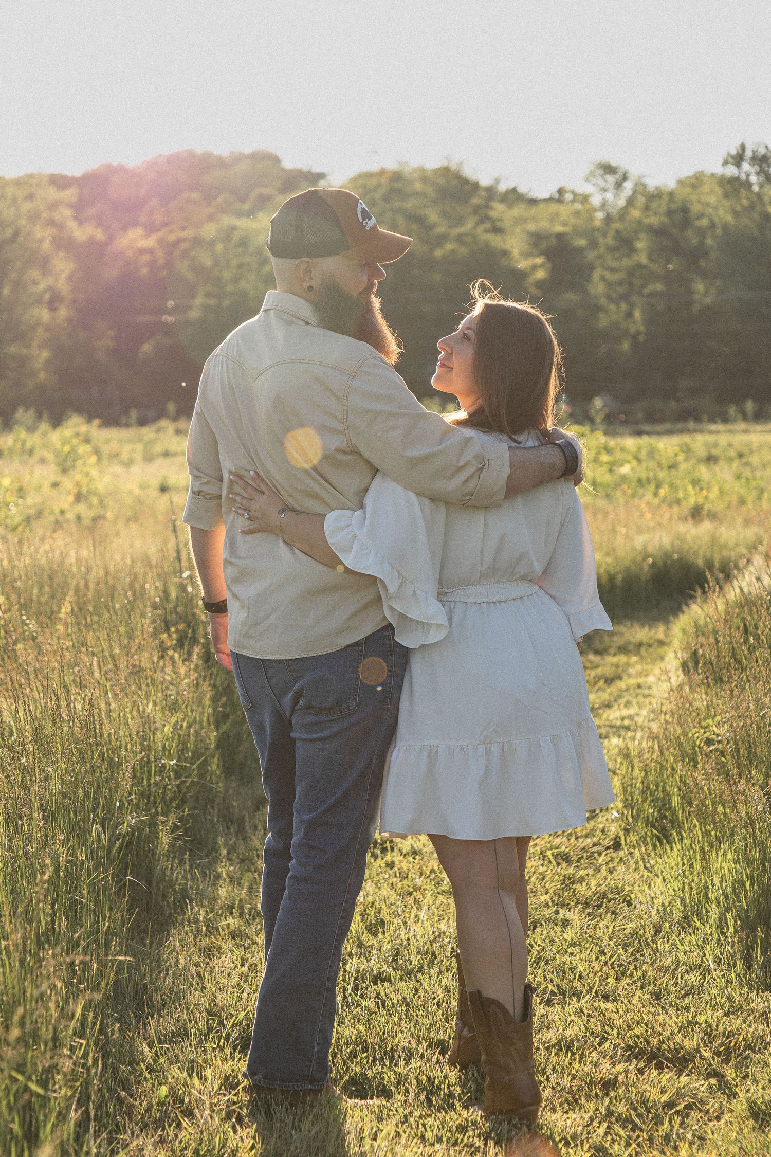 Ohio wedding photographer - Adeva Rae Photography - Couple in field with hills - western attire.