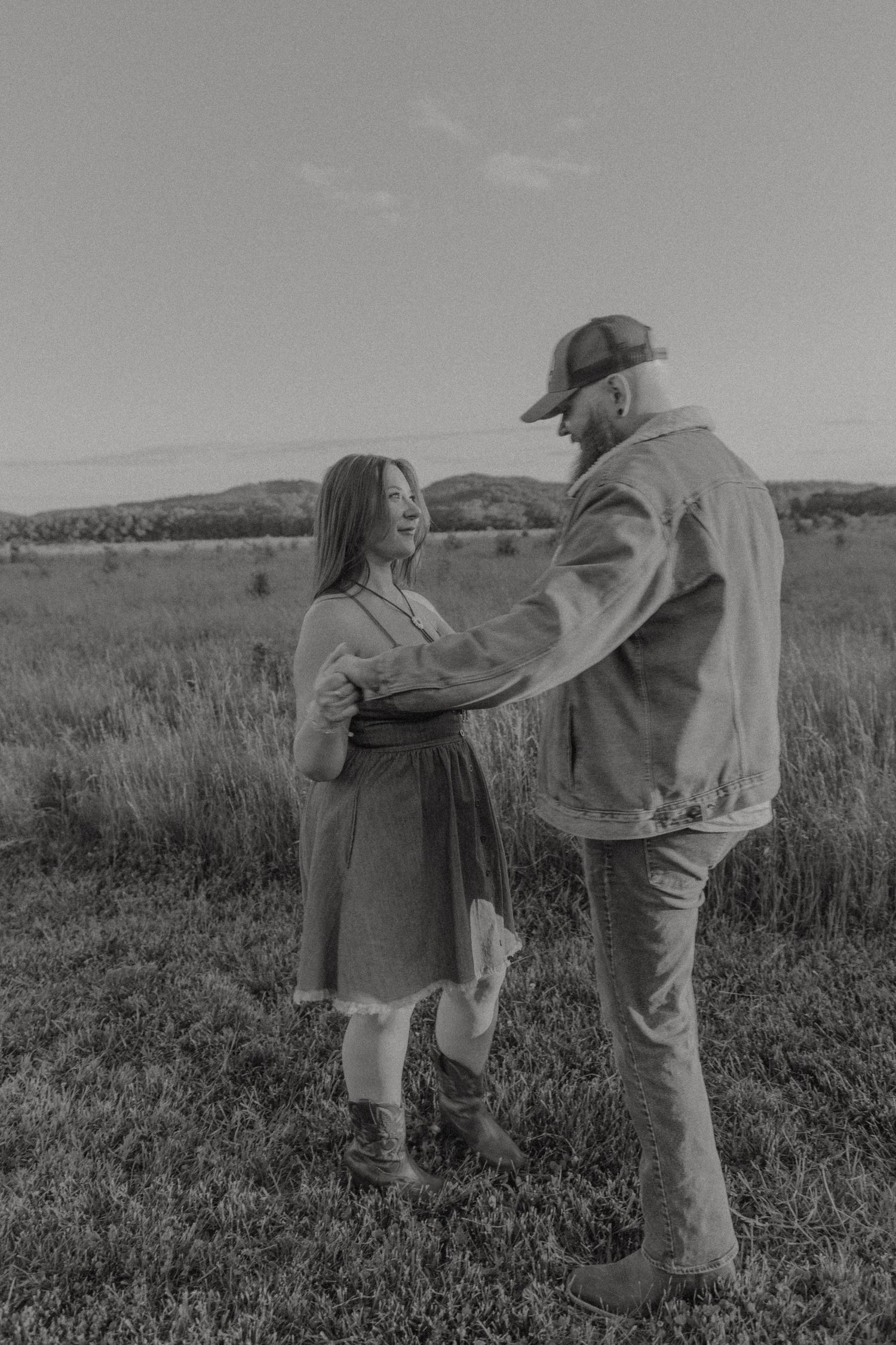 Ohio wedding photographer - Adeva Rae Photography - Couple in field with hills - western attire.