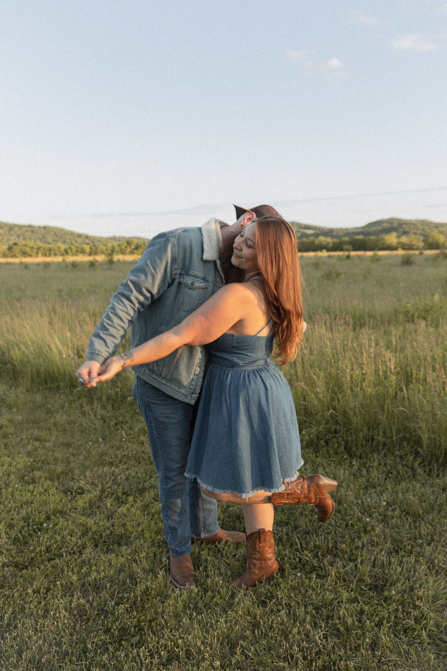 Ohio wedding photographer - Adeva Rae Photography - Couple in field with hills - western attire.
