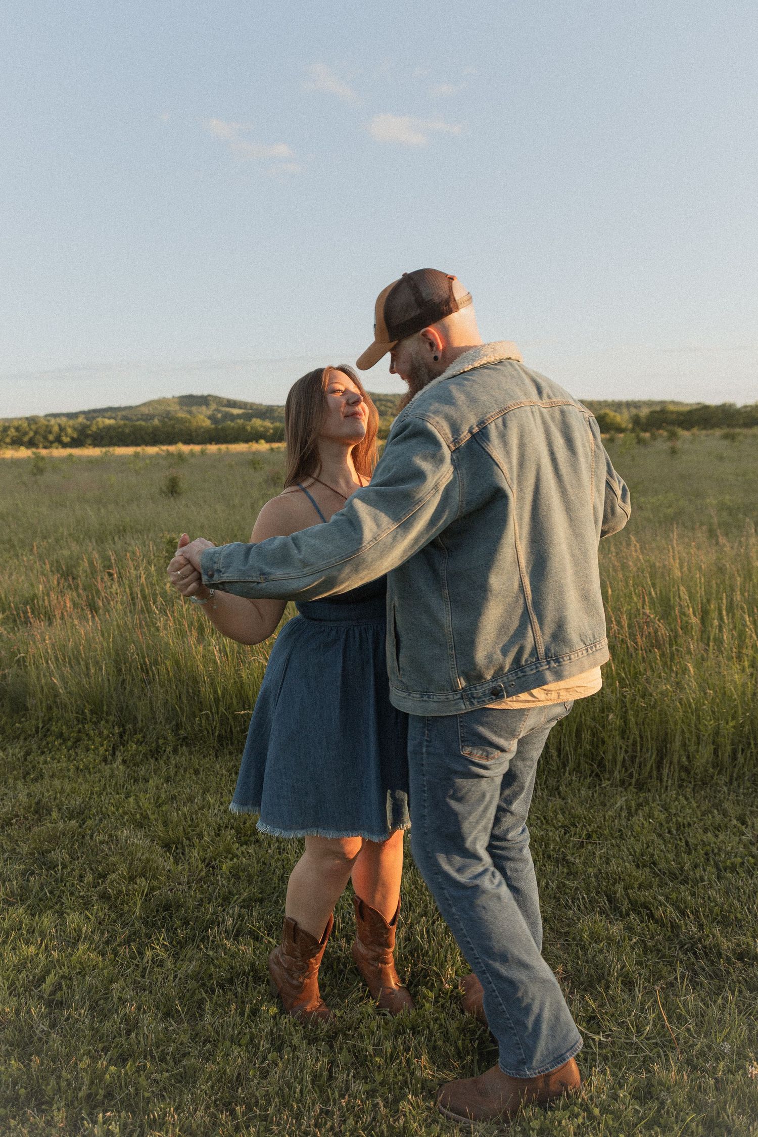 Ohio wedding photographer - Adeva Rae Photography - Couple in field with hills - western attire.