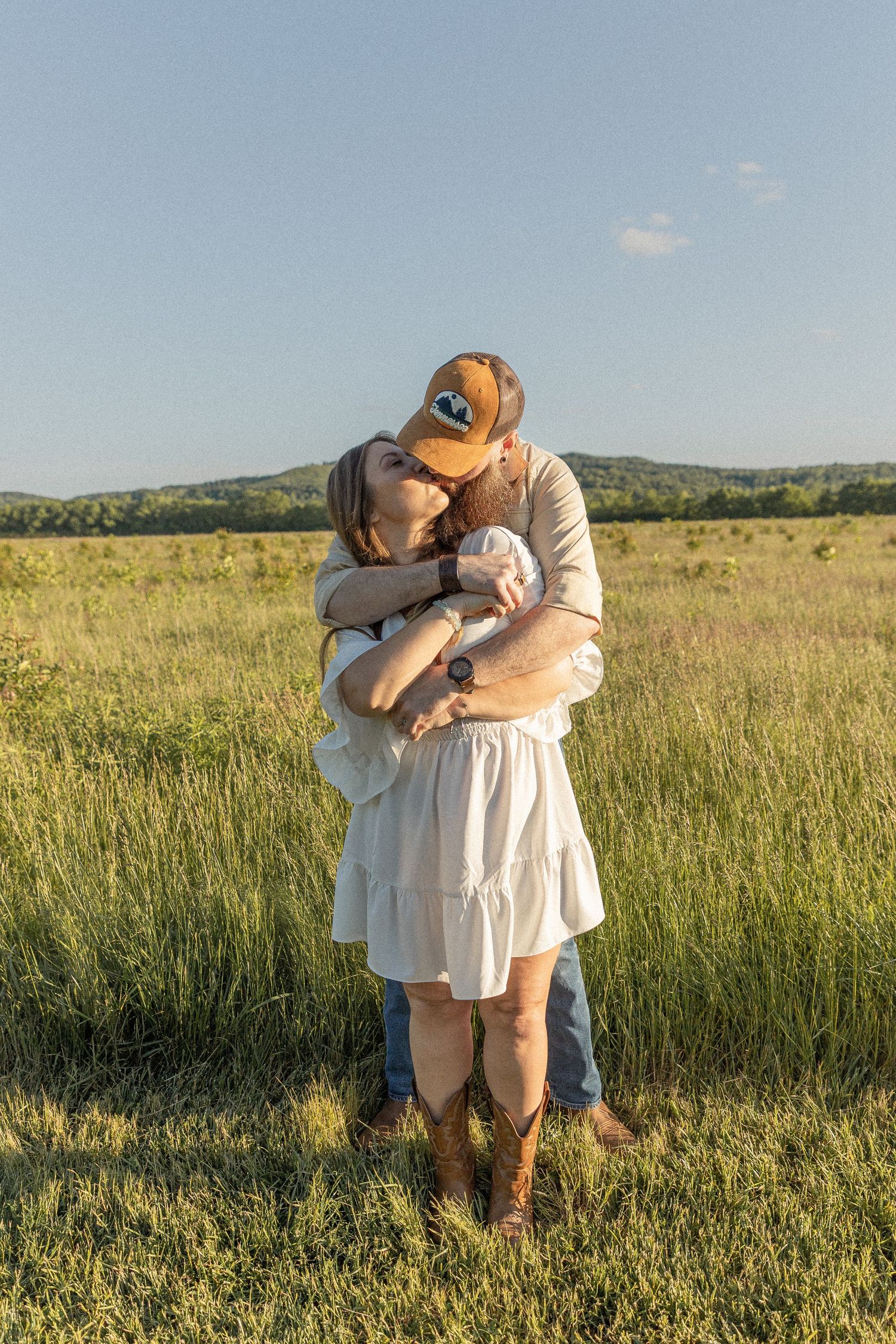Ohio wedding photographer - Adeva Rae Photography - Couple in field with hills - western attire.