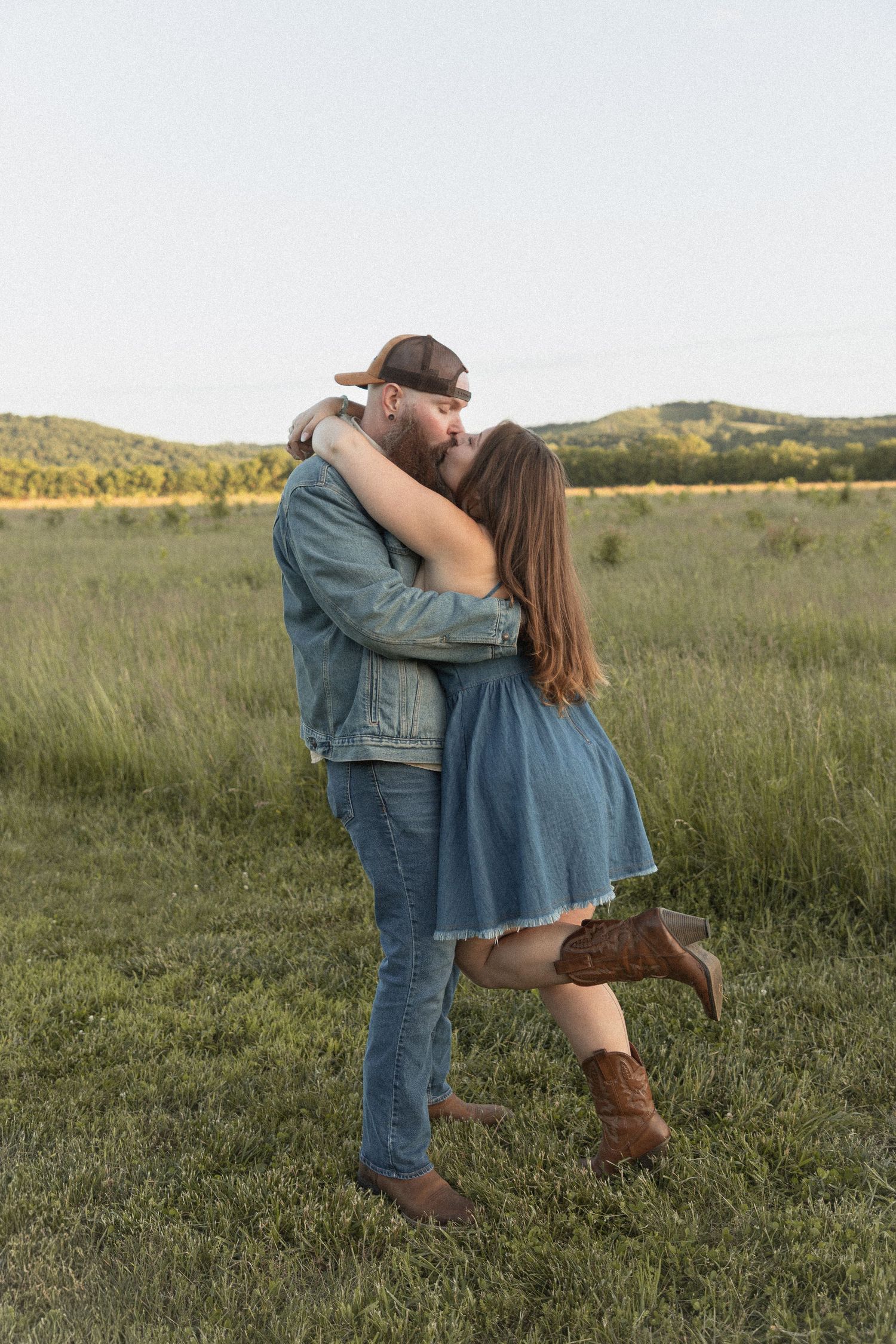 Ohio wedding photographer - Adeva Rae Photography - Couple in field with hills - western attire.