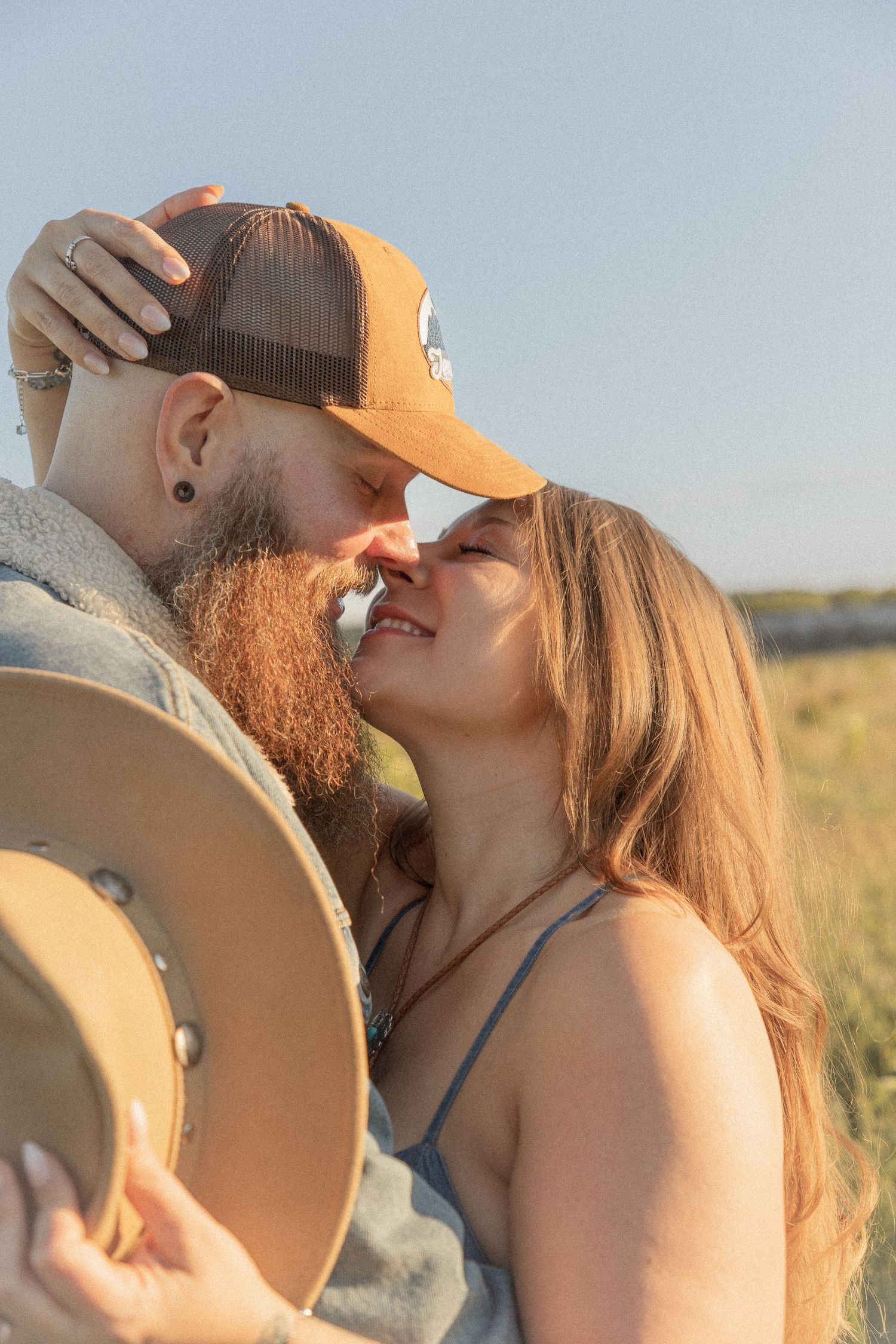 Ohio wedding photographer - Adeva Rae Photography - Couple in field with hills - western attire.