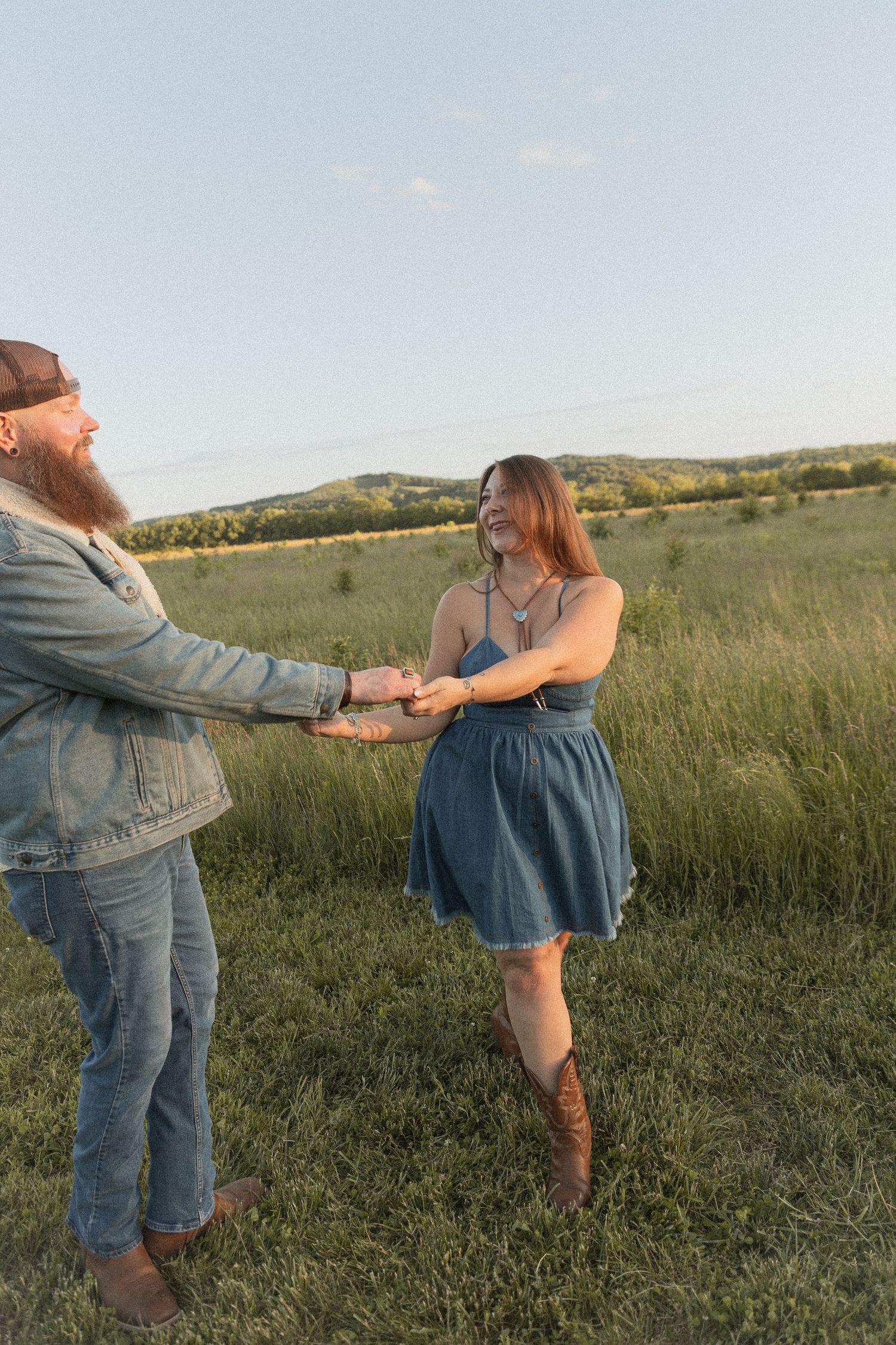 Ohio wedding photographer - Adeva Rae Photography - Couple in field with hills - western attire.