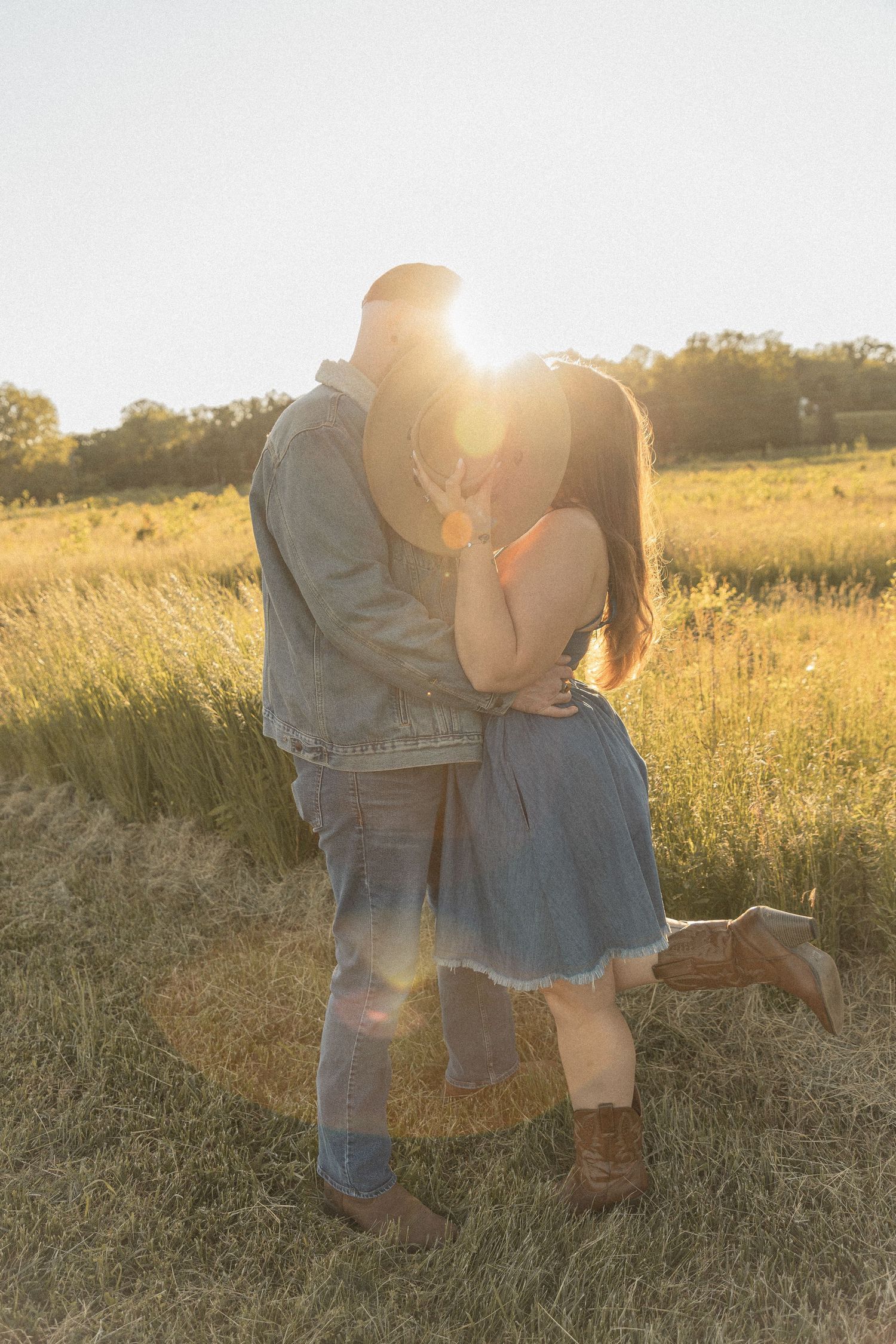 Ohio wedding photographer - Adeva Rae Photography - Couple in field with hills - western attire.
