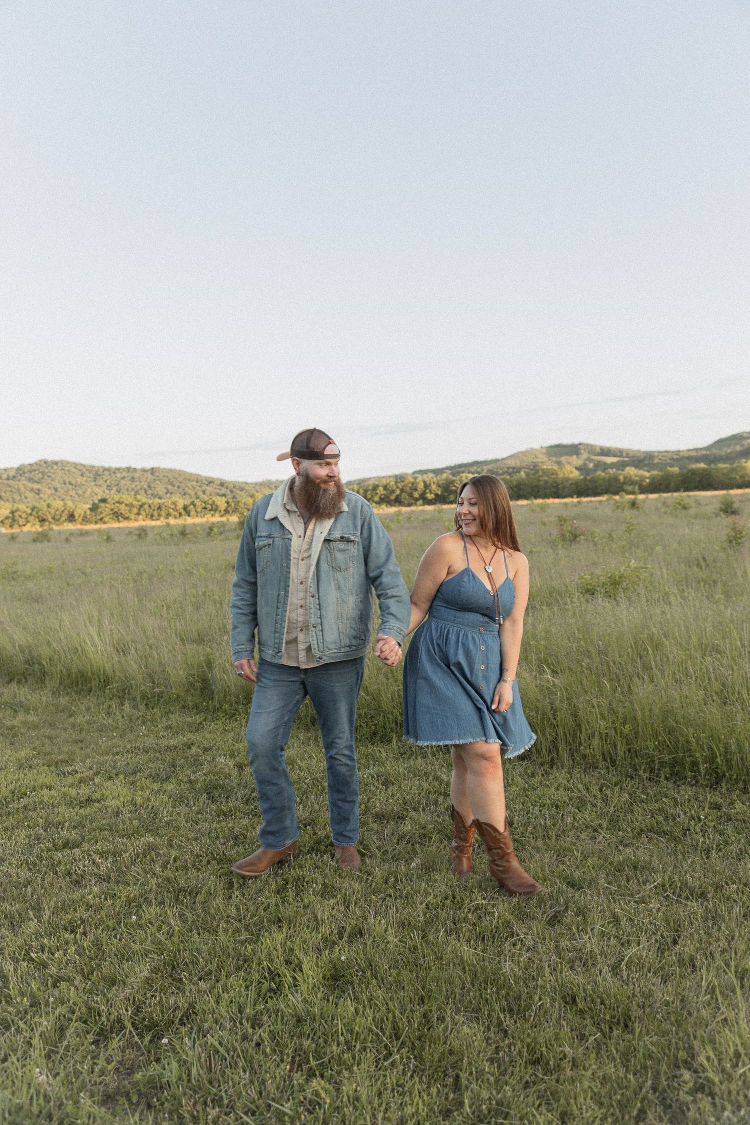 Ohio wedding photographer - Adeva Rae Photography - Couple in field with hills - western attire.