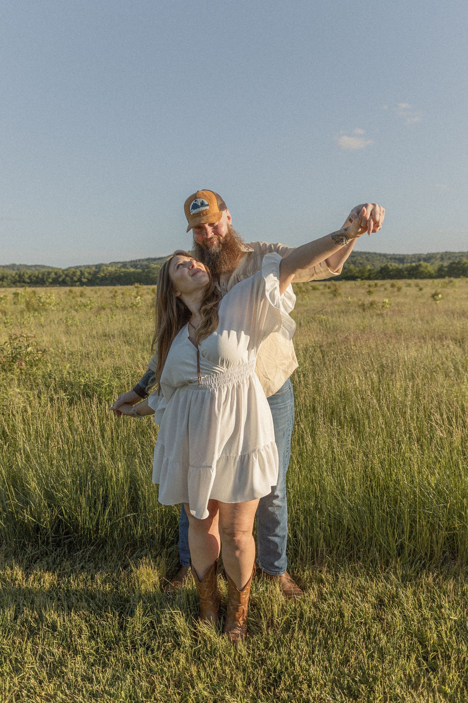 Ohio wedding photographer - Adeva Rae Photography - Couple in field with hills - western attire.