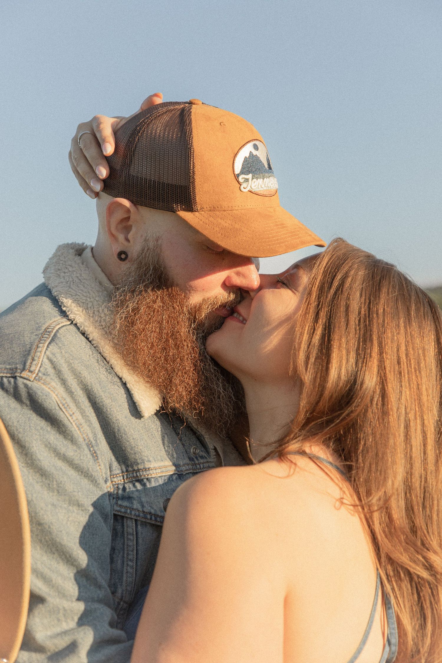 Ohio wedding photographer - Adeva Rae Photography - Couple in field with hills - western attire.