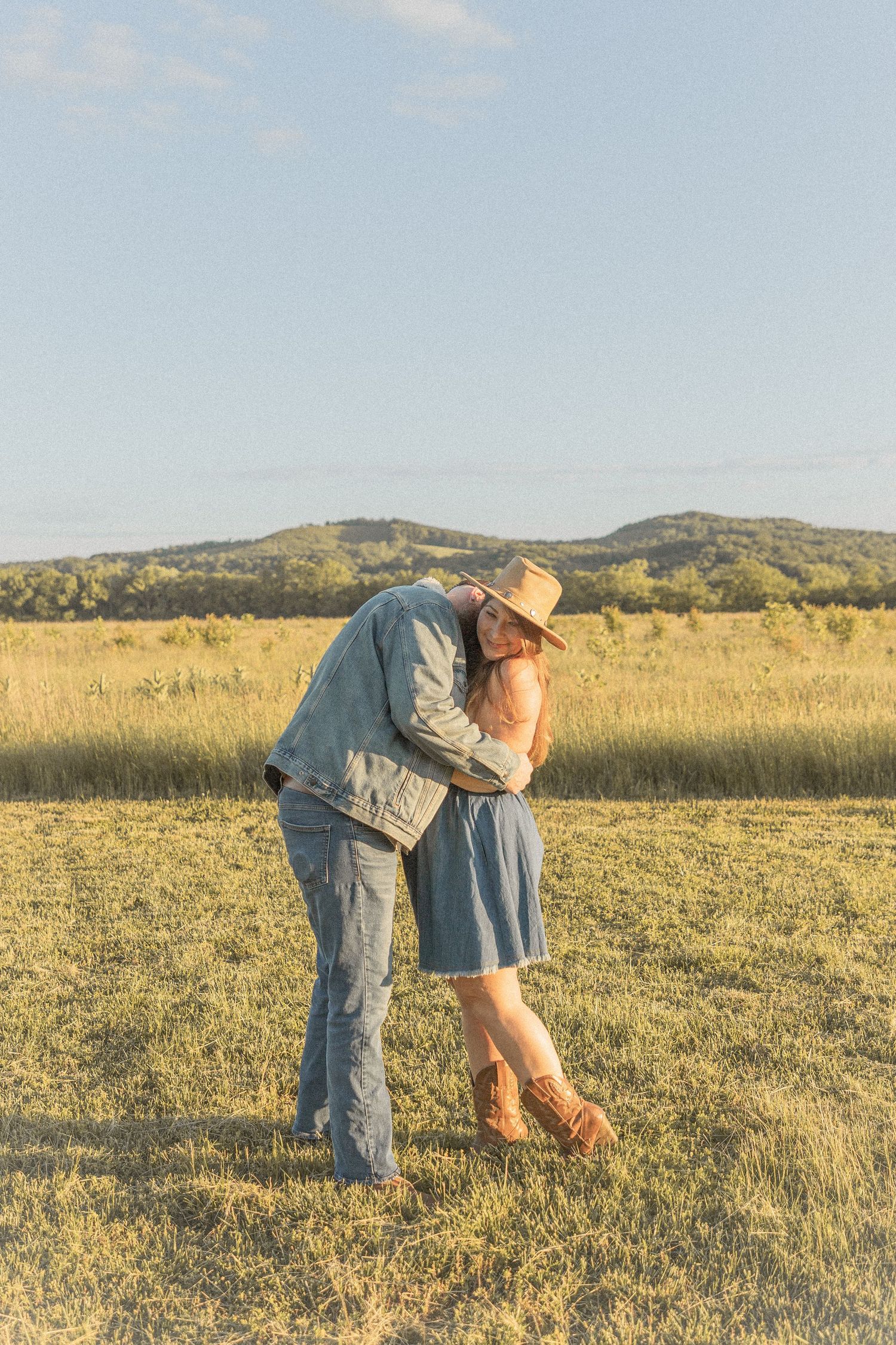 Ohio wedding photographer - Adeva Rae Photography - Couple in field with hills - western attire.