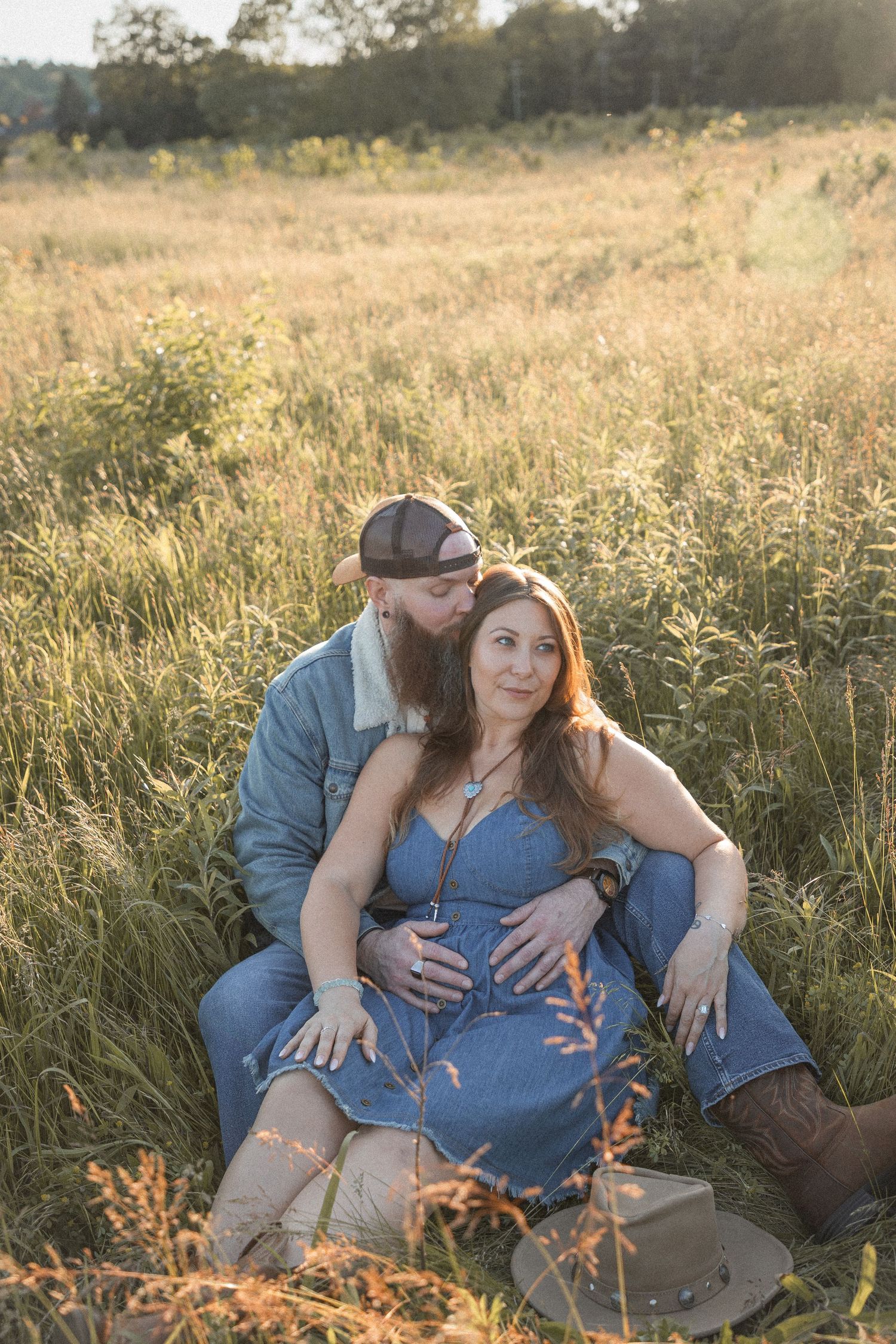 Ohio wedding photographer - Adeva Rae Photography - Couple in field with hills - western attire.