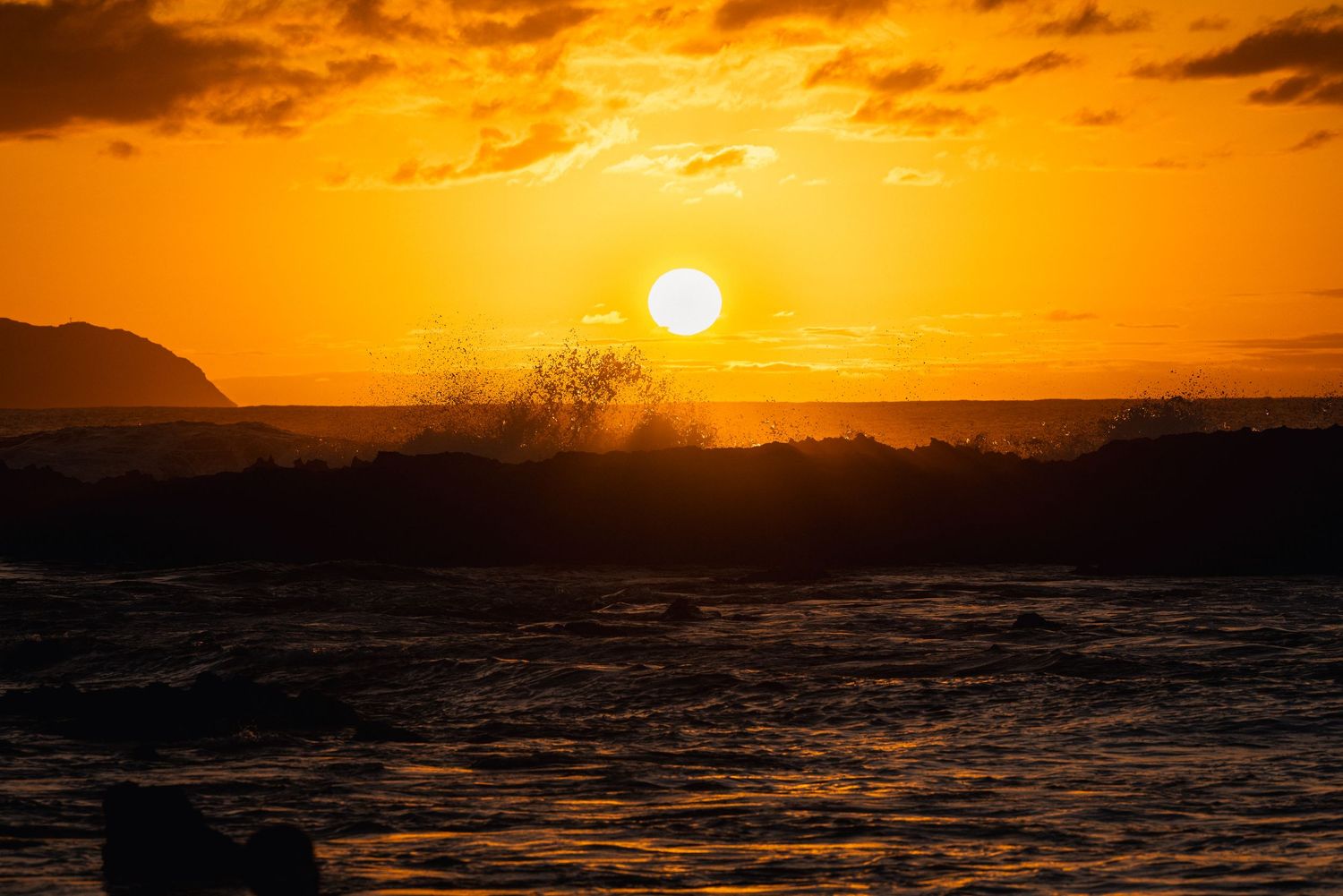 Sunset with crashing wave at Shark's Cove on the North Shore of Oahu, Hawaii. Taken by Fort Lauderdale photographer James Ferriero.