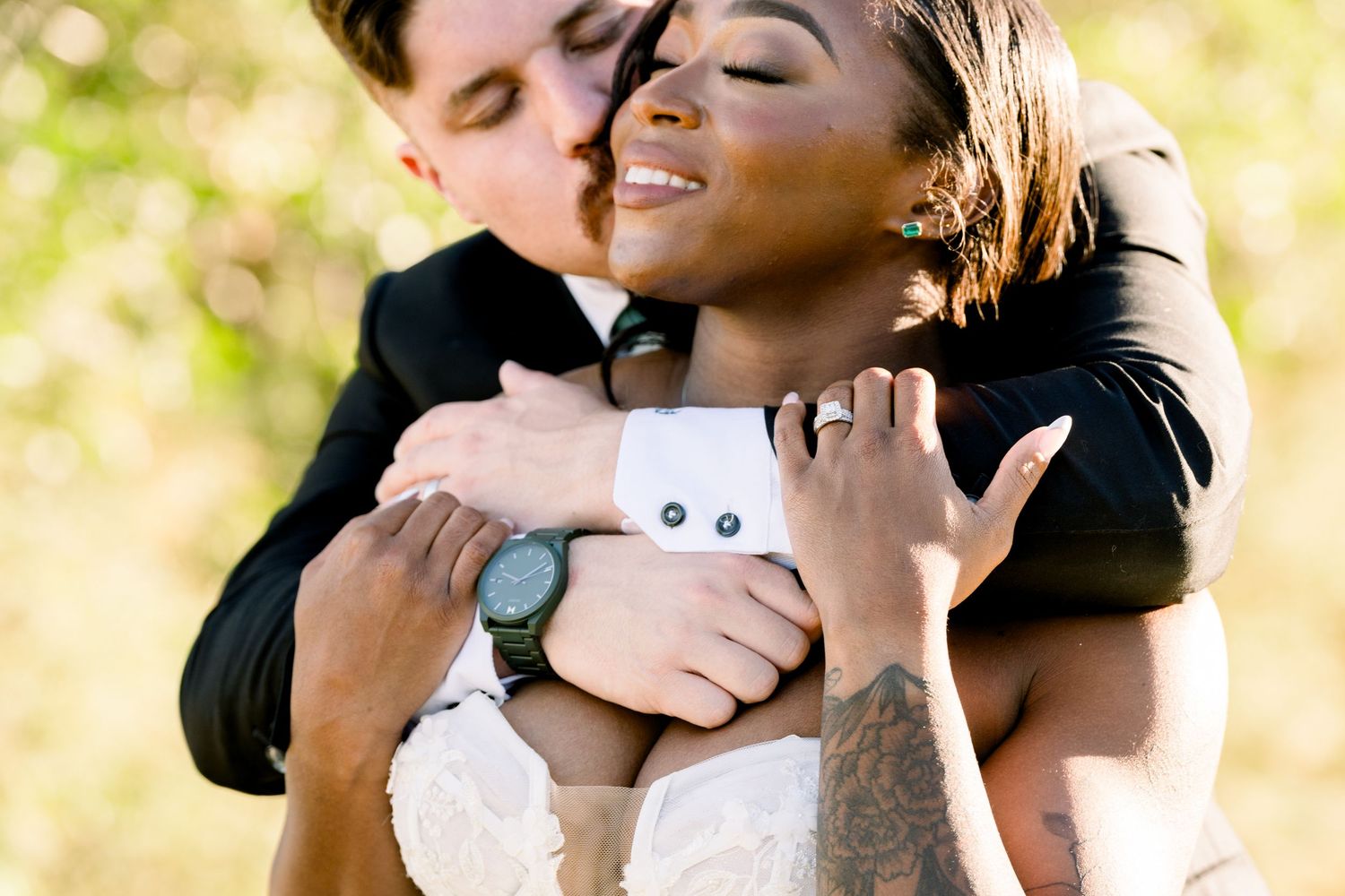 Intimate moment between newlyweds captured during outdoor wedding portraits.