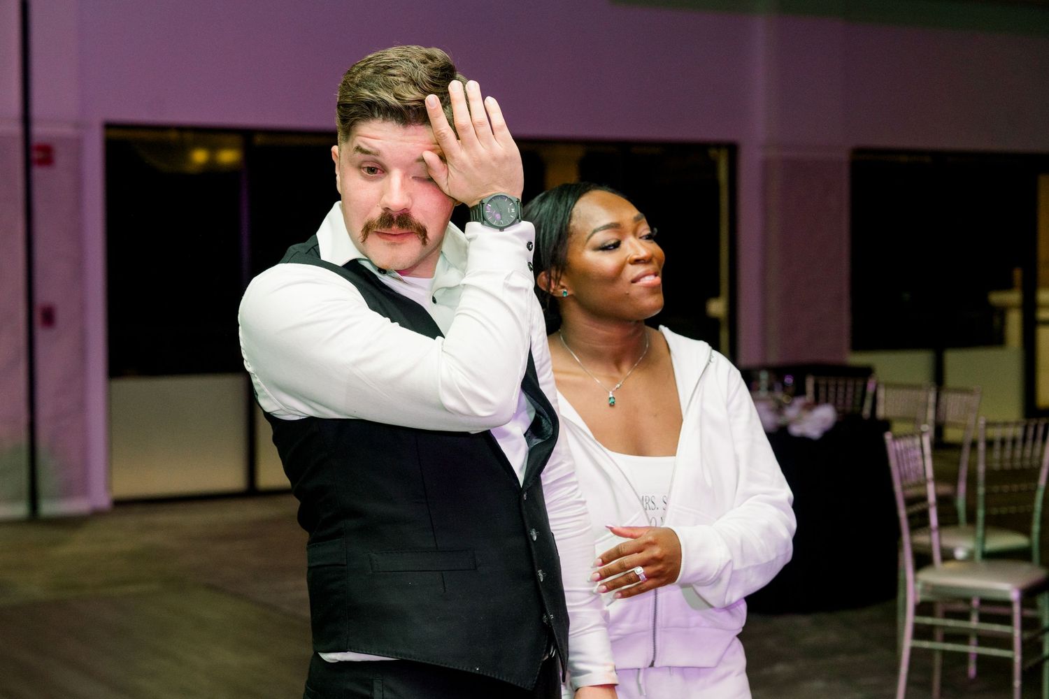 Candid reception moment showing couple's emotional reaction.
