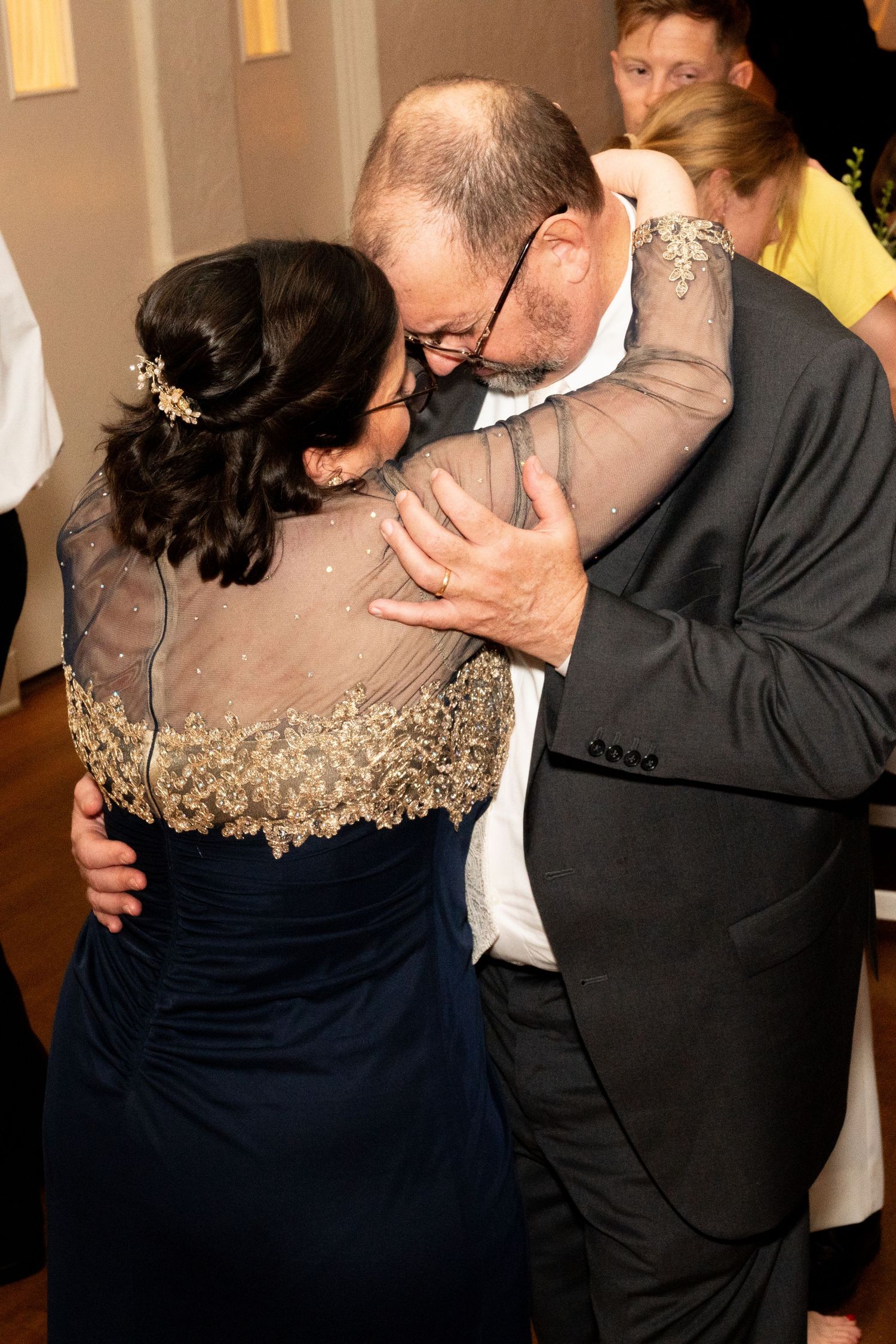A couple shares an intimate dance moment at a formal event.
