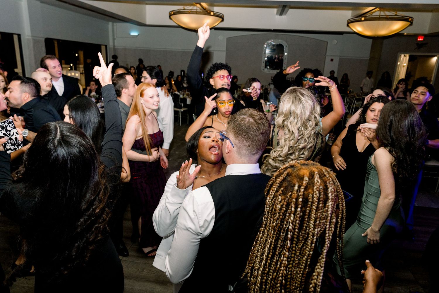 Energetic wedding reception dance floor filled with guests enjoying the celebration.