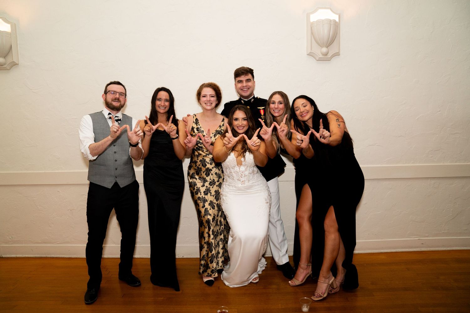 A group of wedding guests pose together for a fun photo at the reception.