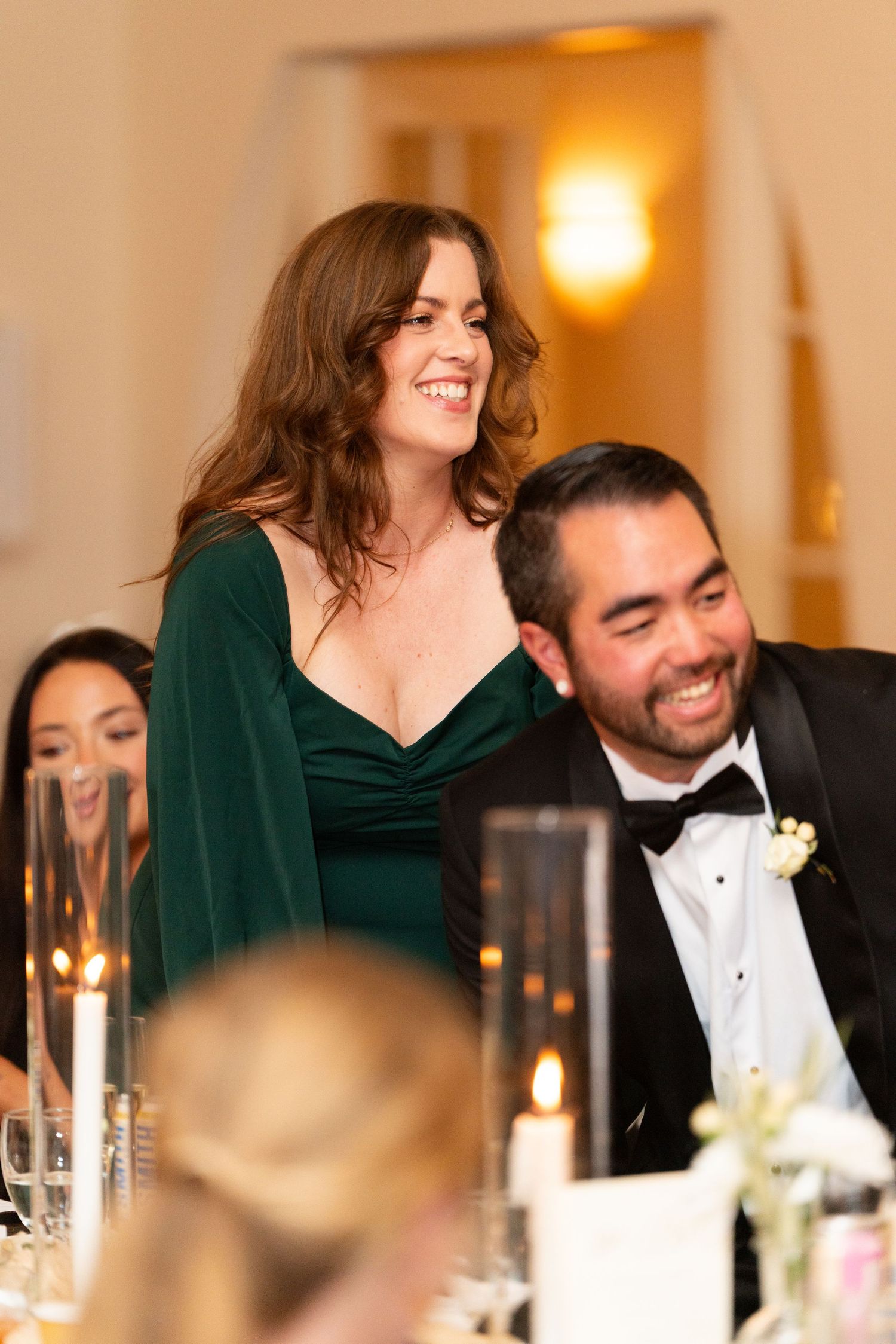Candlelit reception dinner with guests enjoying formal celebration.