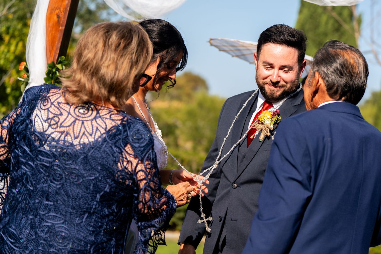 Wedding guests and family members sharing an intimate moment during an outdoor celebration.