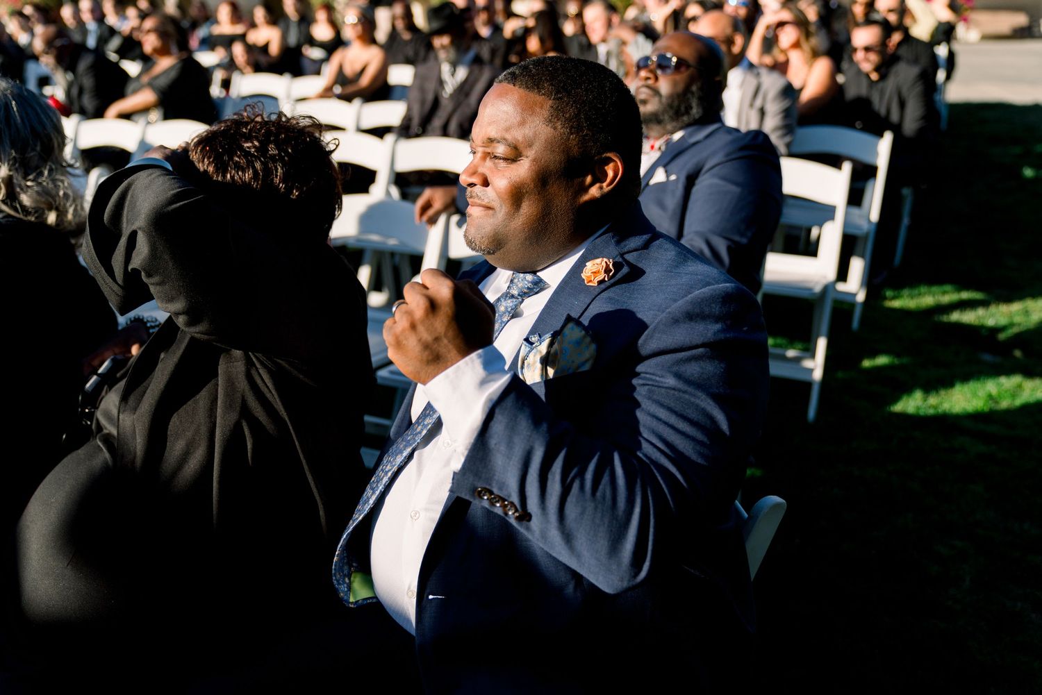 Wedding guest sharing an emotional moment during outdoor reception.