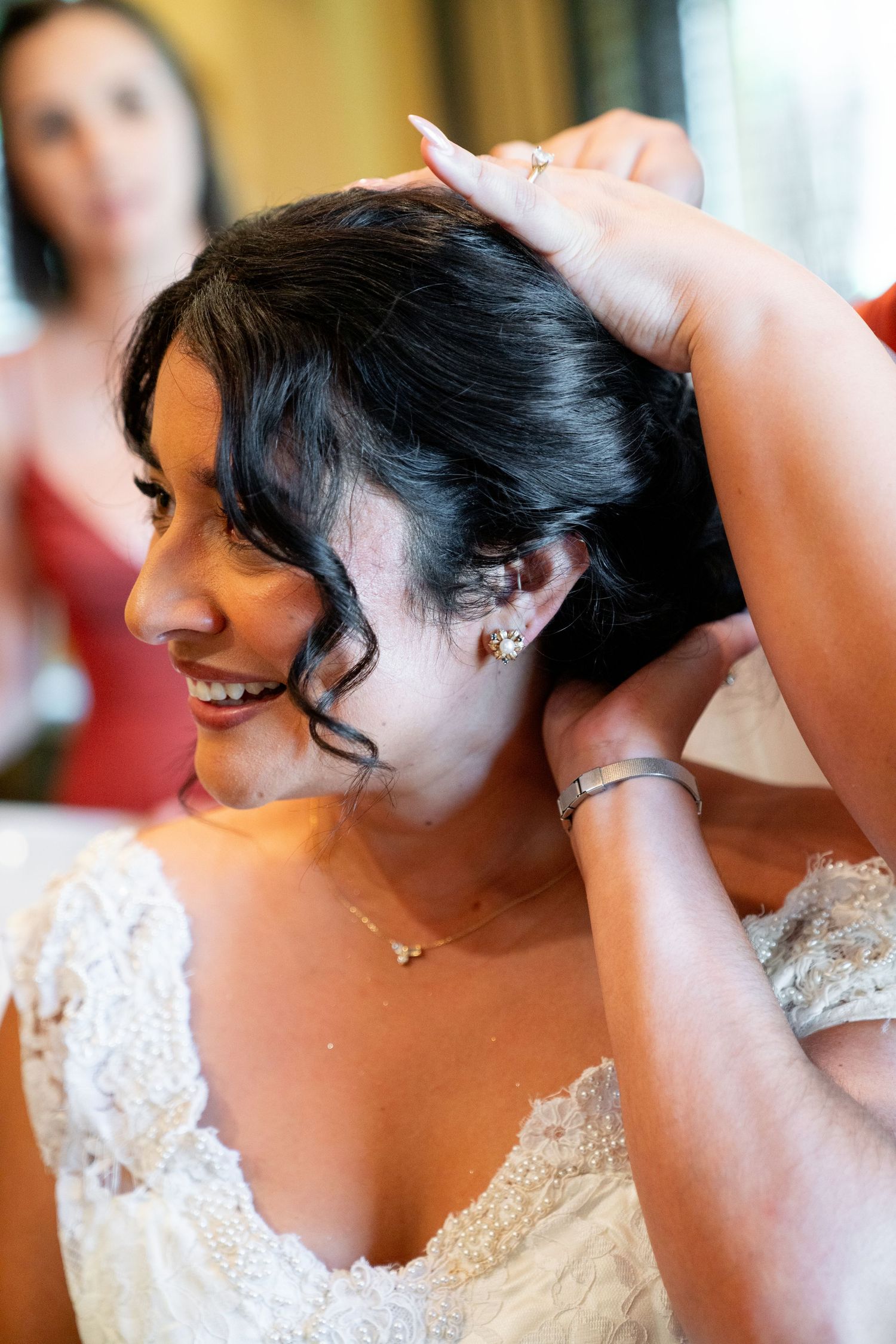 Elegant bride getting ready while wearing a delicate lace wedding dress for her special day.