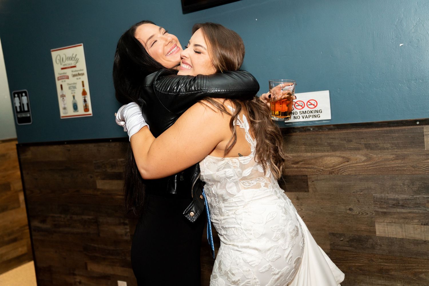 An emotional embrace between two people during a wedding celebration.