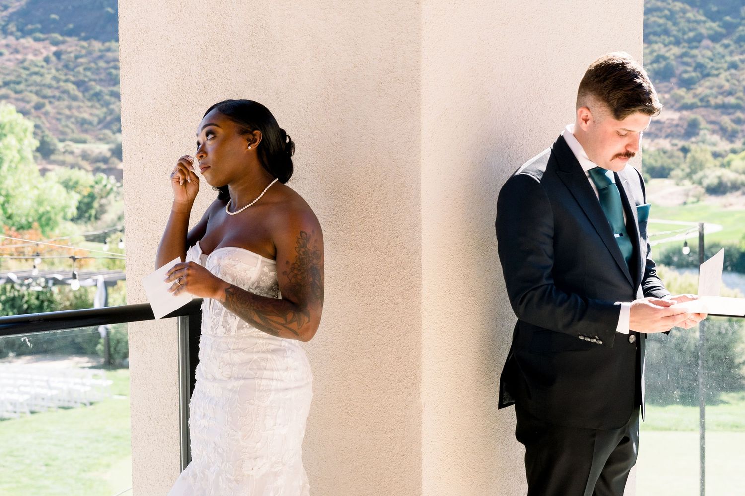 Couple standing on opposite sides of a pillar during their first look wedding moment.