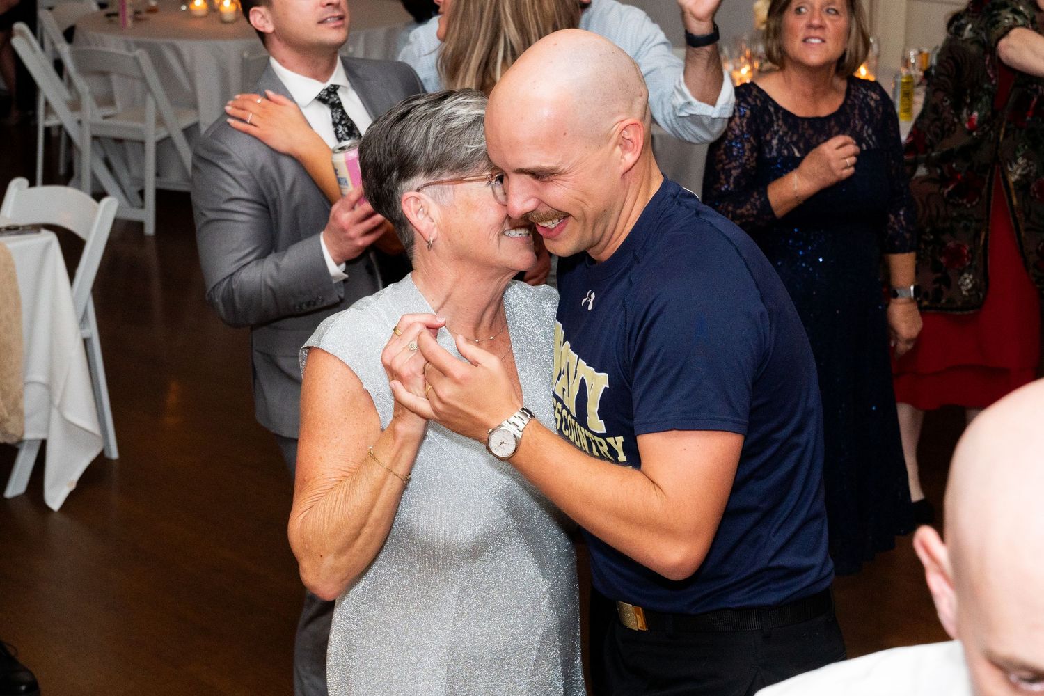 A couple shares a joyful dance moment during their wedding reception.