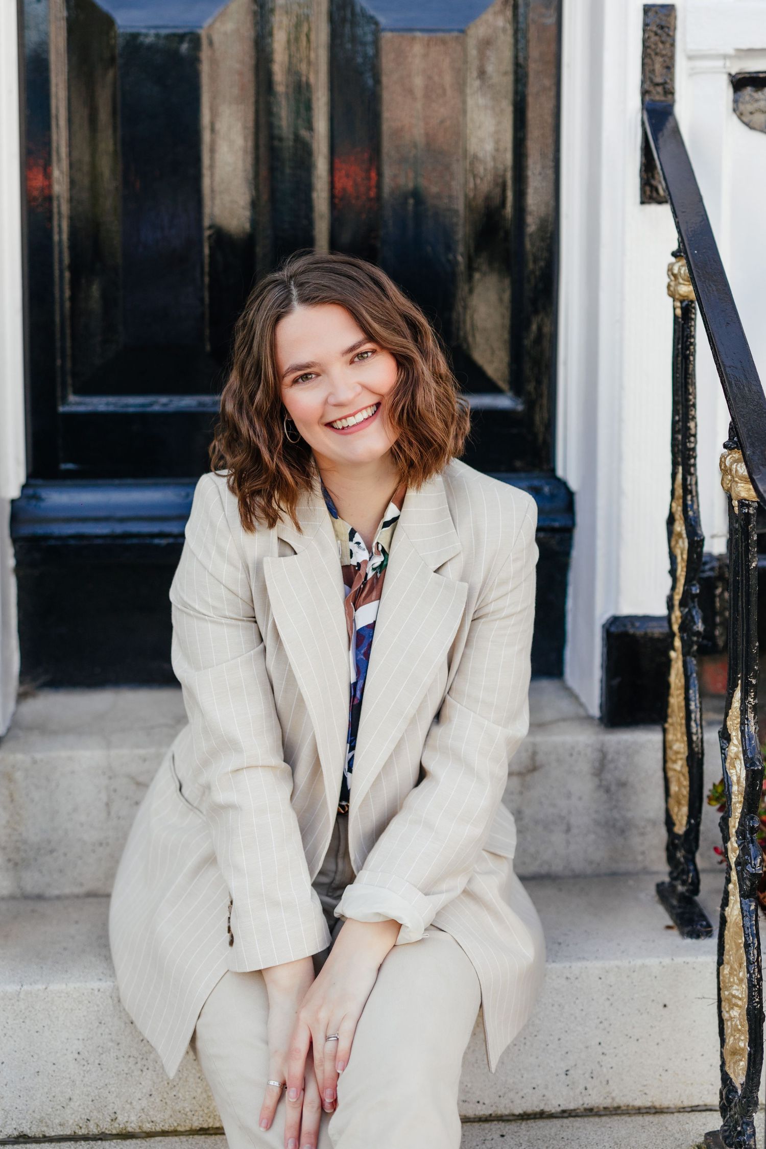 Portrait headshot of photographer sitting on steps