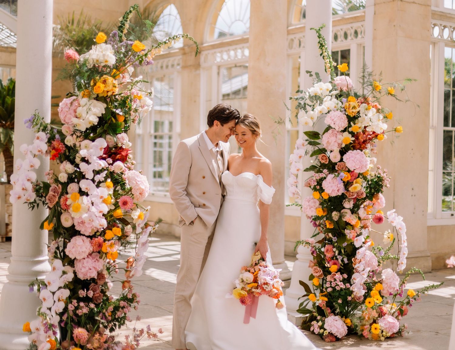 Bride and groom smiling at alter in Syon House Park